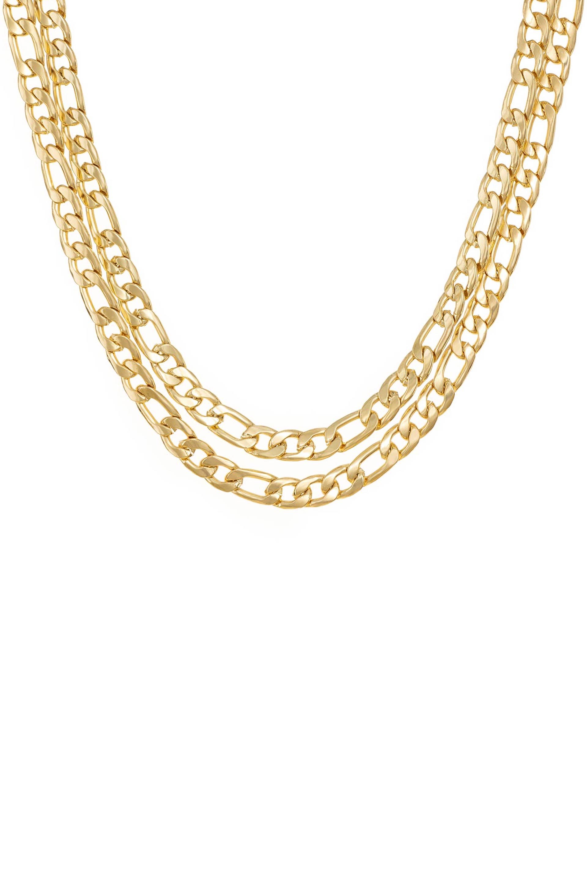 A trio of gold chains hangs in a cascading manner, reflecting light against a plain white background, creating a striking visual of elegance and luxury.