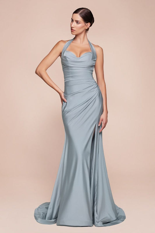 A model stands confidently in a sleek, light blue evening gown with a fitted bodice and a thigh-high slit, against a soft, neutral background.