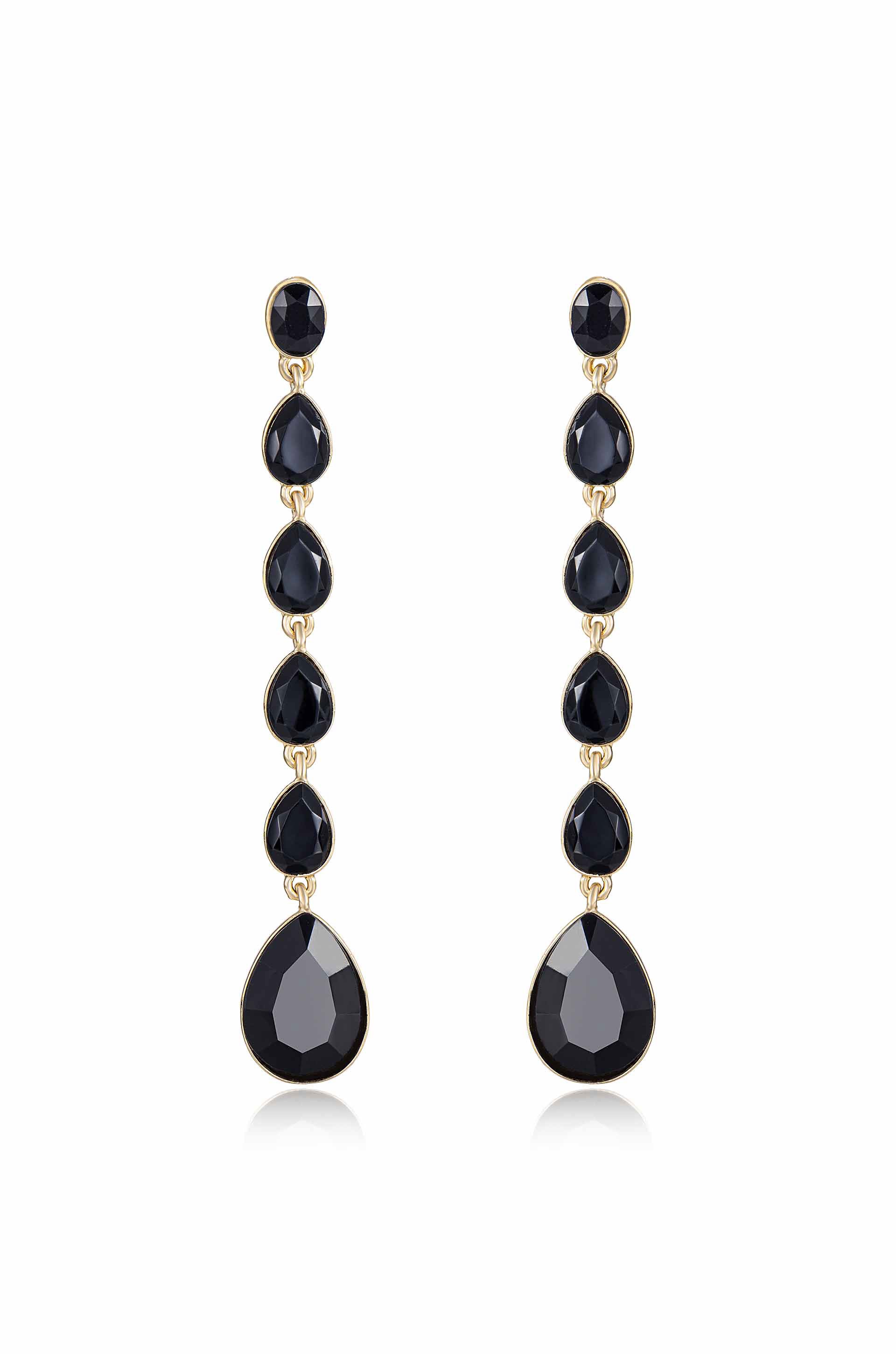 Elegant drop earrings feature a vertical arrangement of black stones, including faceted round and teardrop shapes, all set in a gold-tone metal, creating a sophisticated accessory.