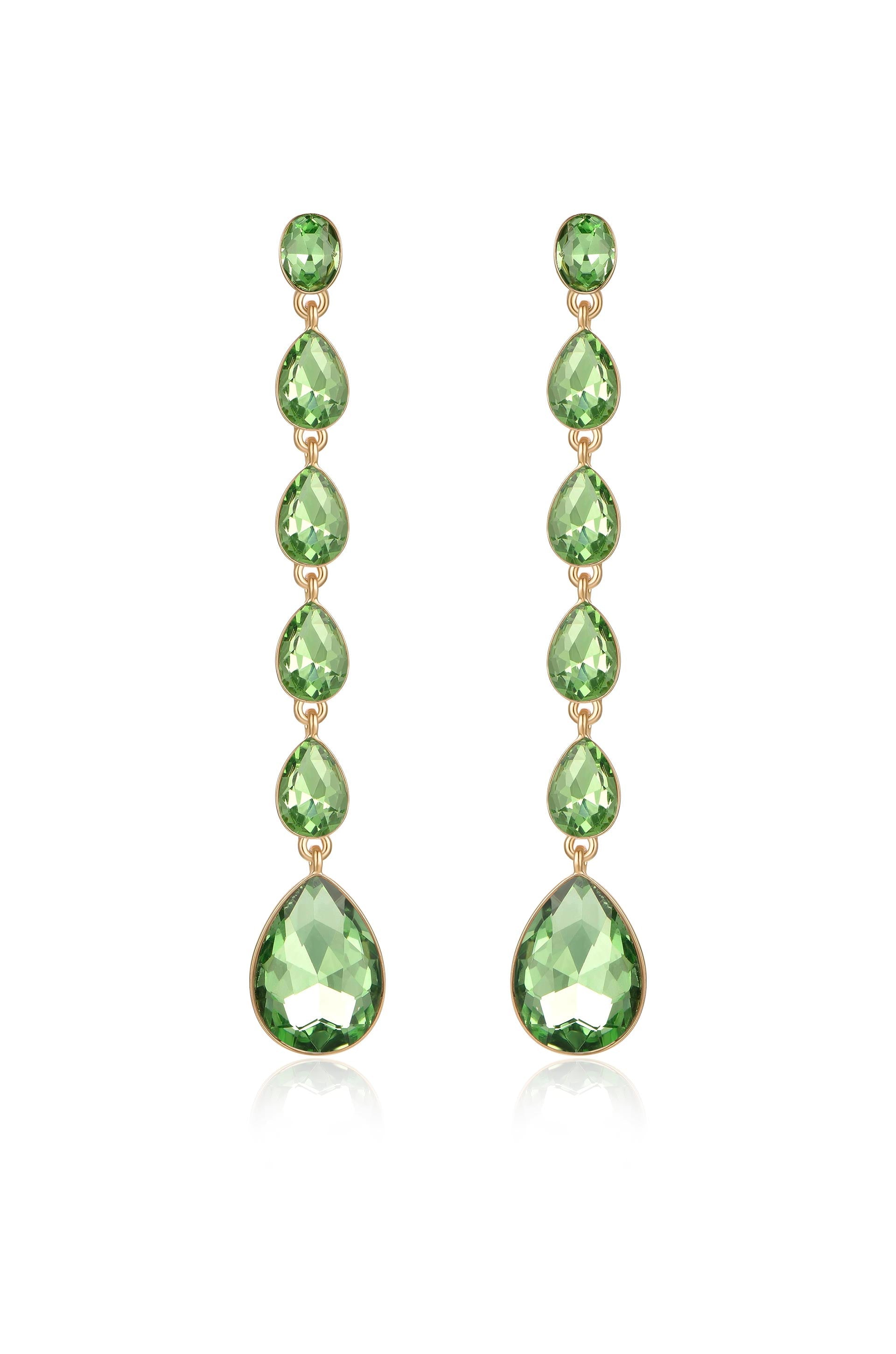 Elegant earrings feature a vertical arrangement of green gemstones in various teardrop shapes, hanging from a gold setting, reflecting light against a neutral background.