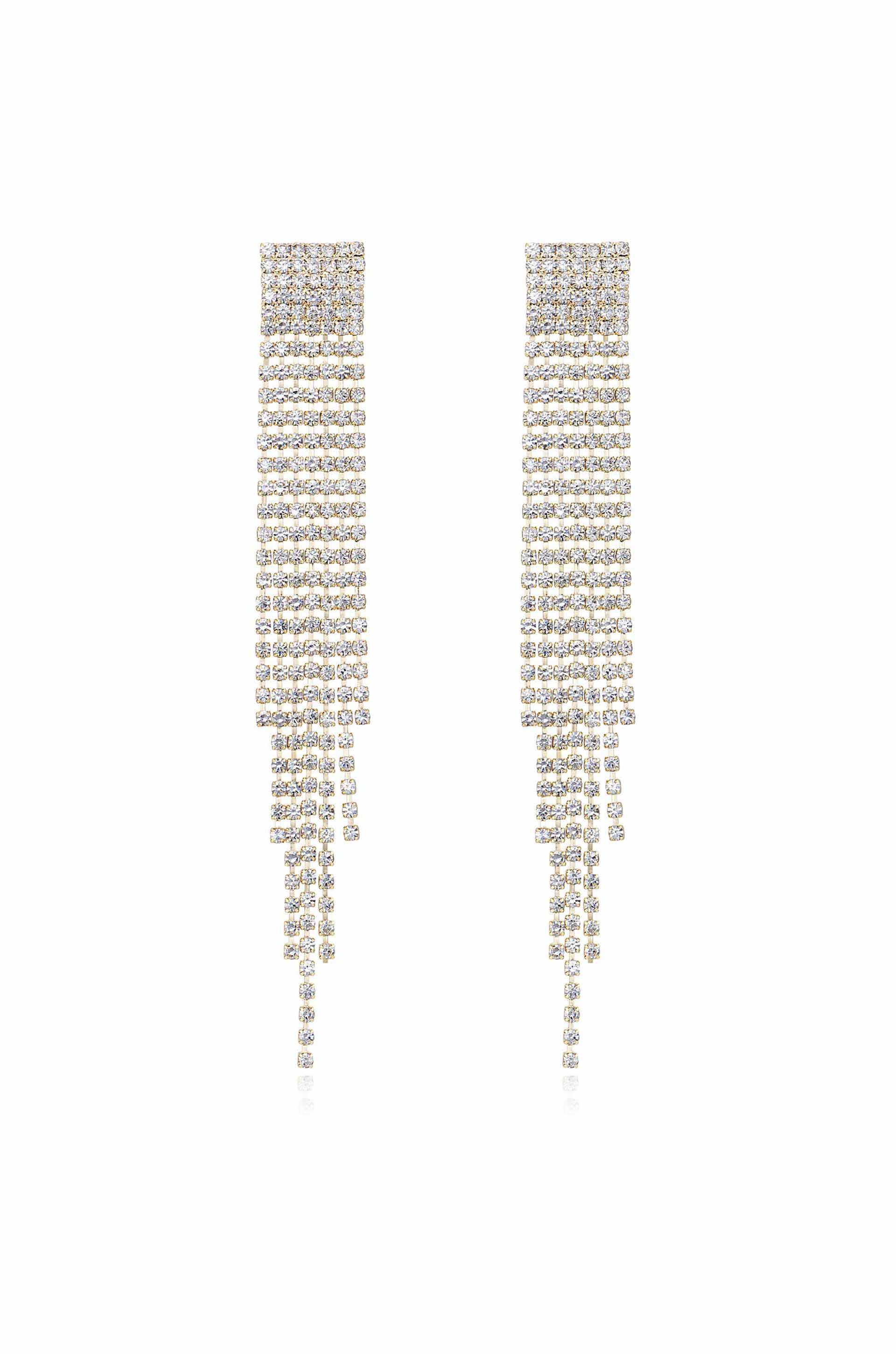 Sparkling dangle earrings hang vertically, featuring a series of shiny rhinestones arranged in cascading rows. The background is plain white, highlighting the earrings' elegance and shine.