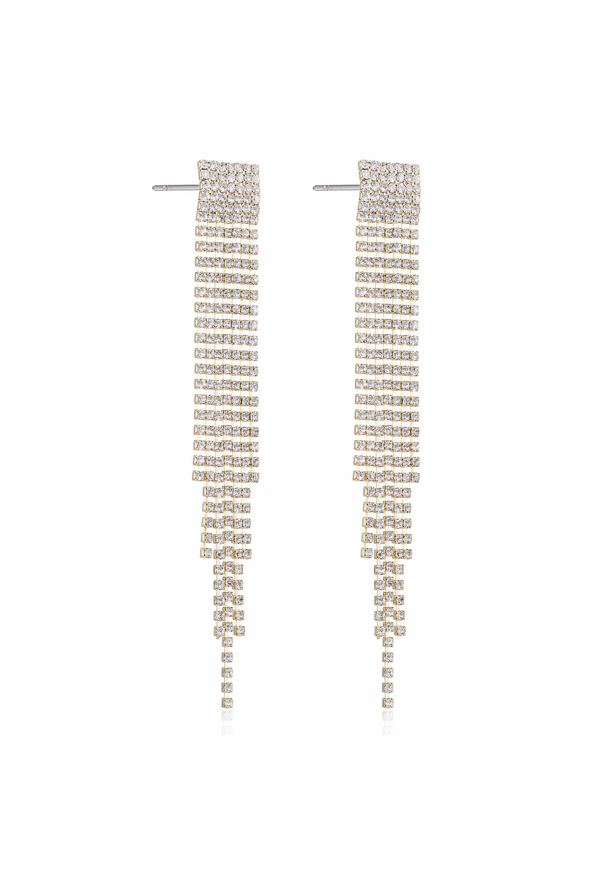 Two elegant earrings, adorned with shimmering diamonds, hang vertically. Their intricate design cascades down in layered strands, set against a plain background, suggesting sophistication and luxury.