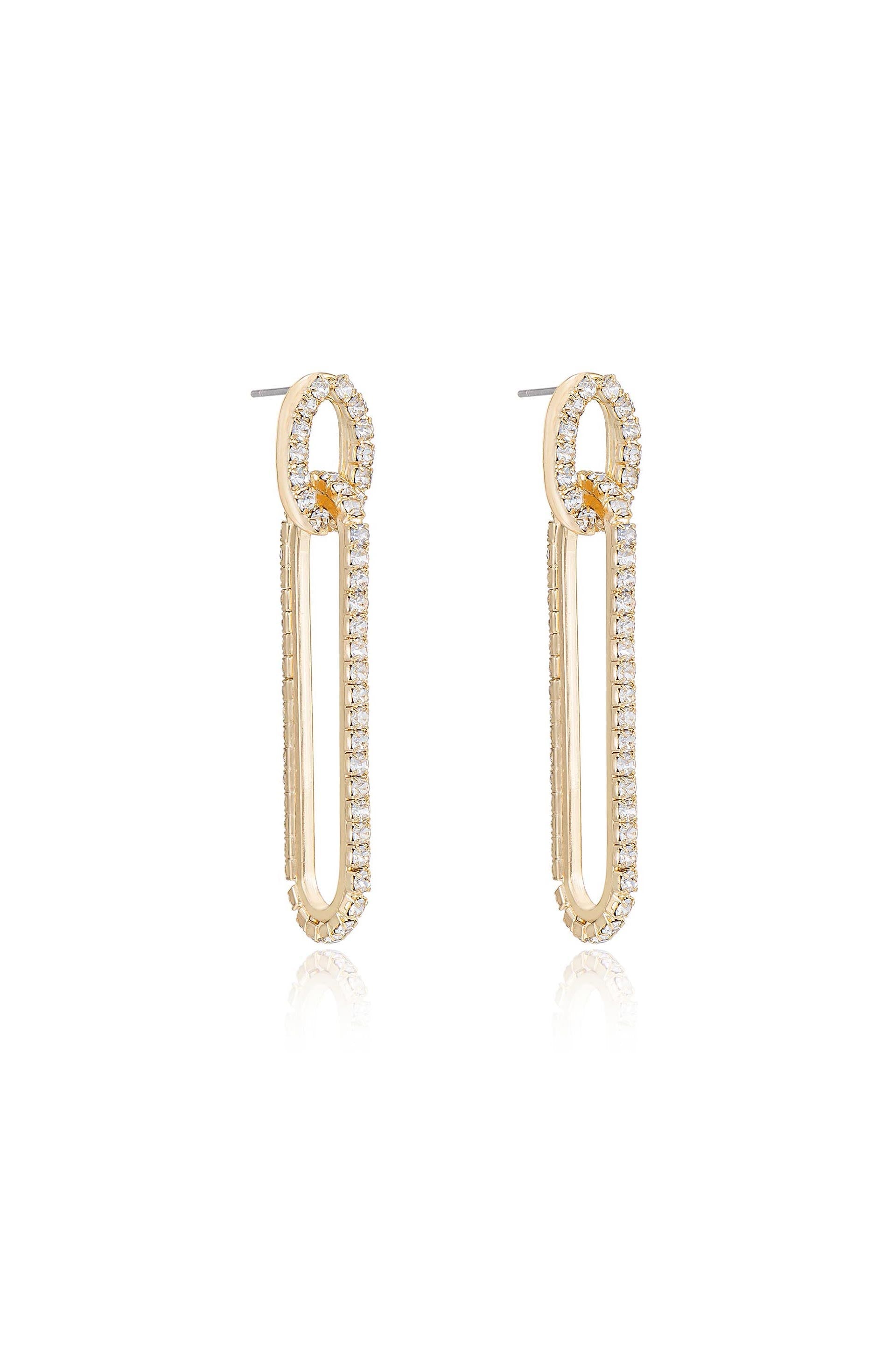 Gold hoop earrings with a unique elongated shape feature a row of sparkling diamonds along the outer edge, displayed against a reflective white background.