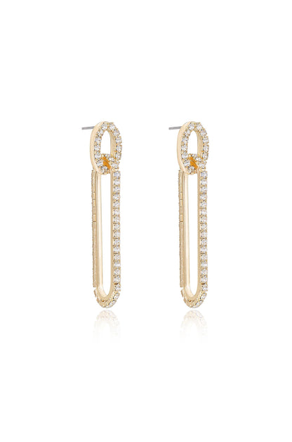 Gold hoop earrings with a unique elongated shape feature a row of sparkling diamonds along the outer edge, displayed against a reflective white background.