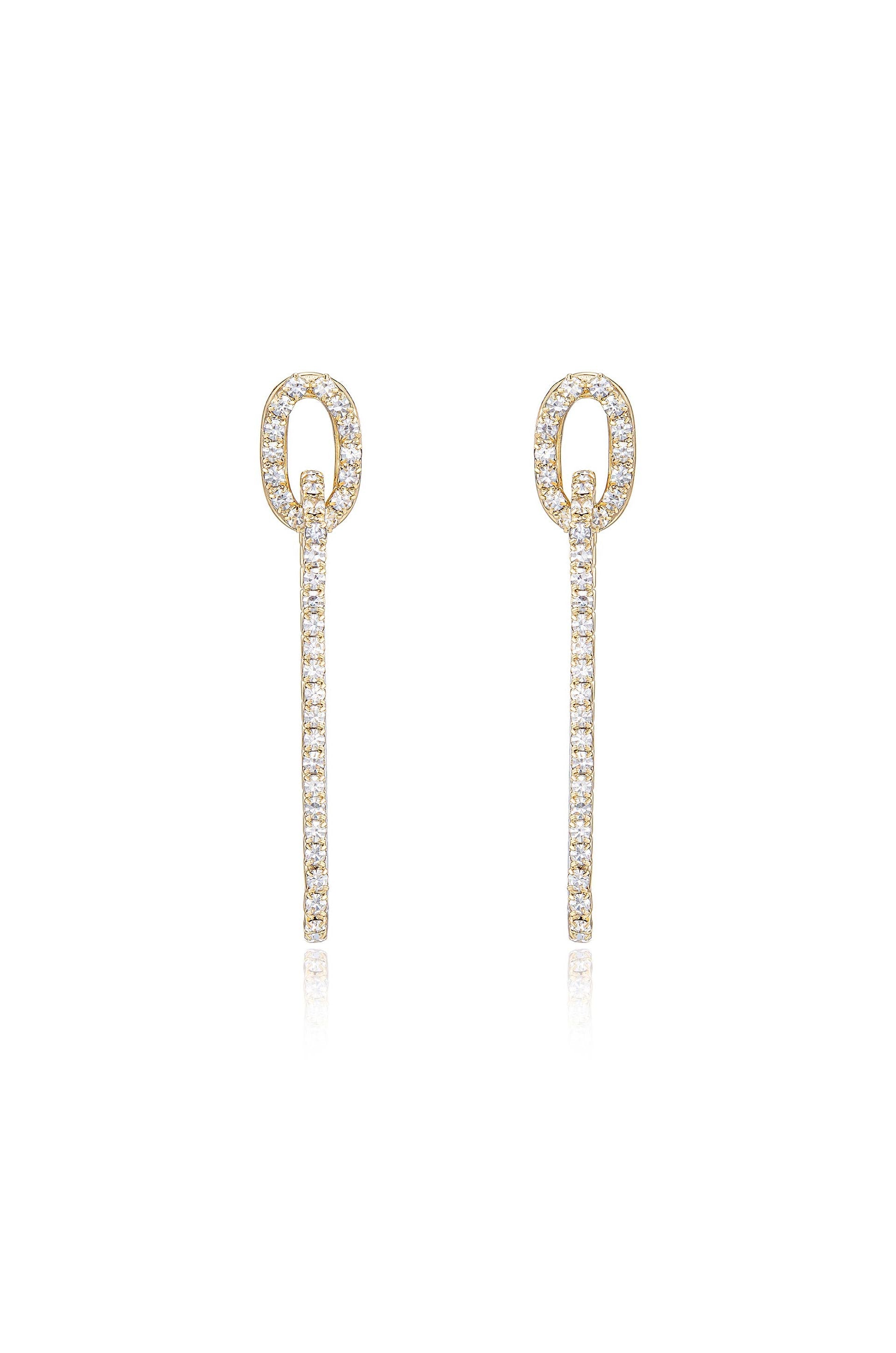 Two elegant golden earrings hang vertically, featuring a circular top and a linear drop adorned with sparkling crystals, set against a clean, bright background.