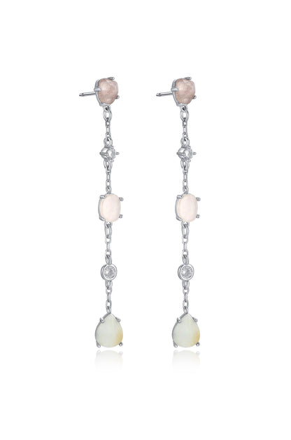 Dangle earrings with a silver chain feature a combination of pink and white stones, interspersed with small diamond-like accents, reflecting light against a simple, neutral background.