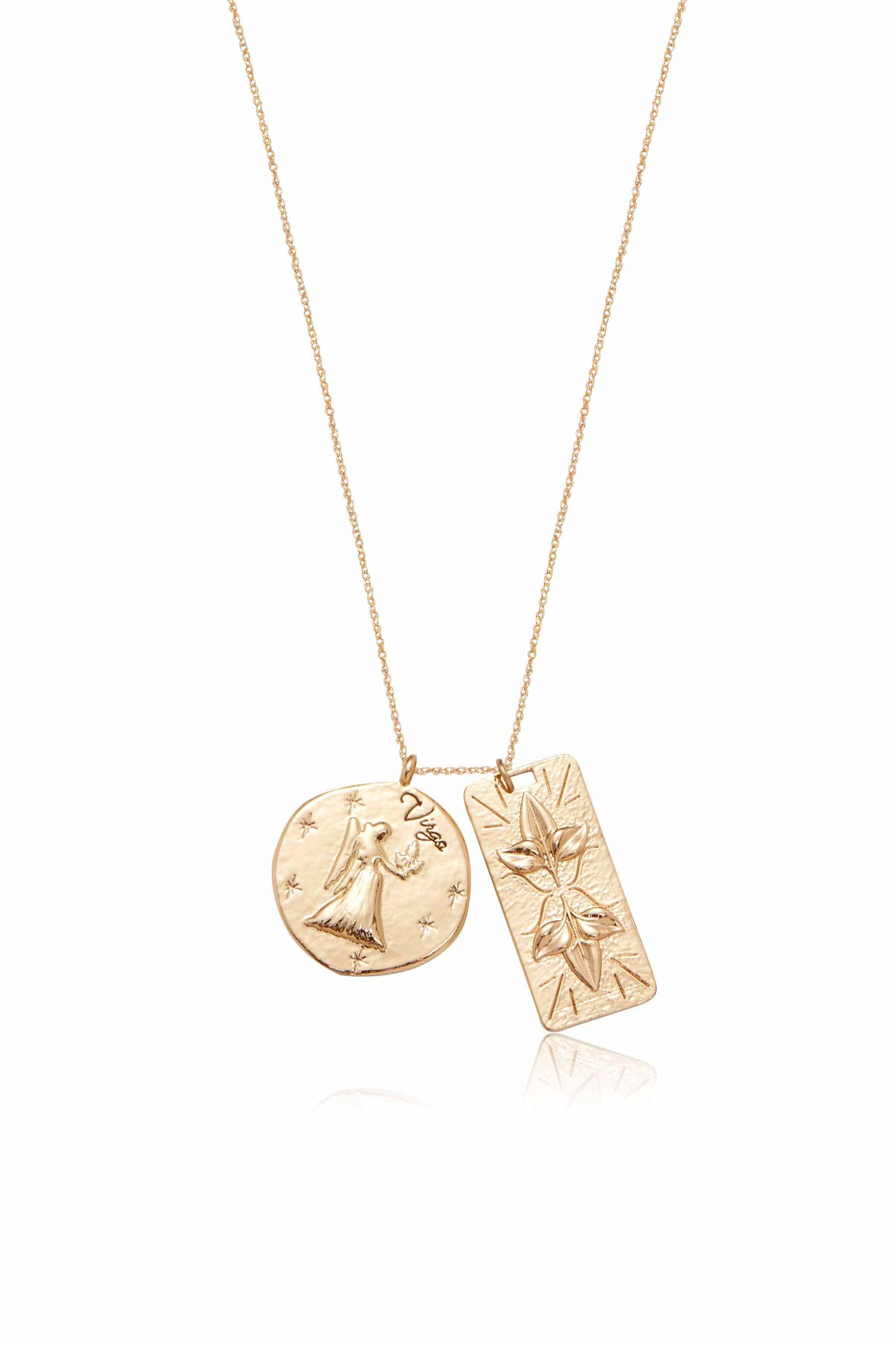 A gold necklace features two pendants: one circular with an angel design and "Virgo," and a rectangular pendant embossed with stylized flowers. It's displayed against a neutral background.