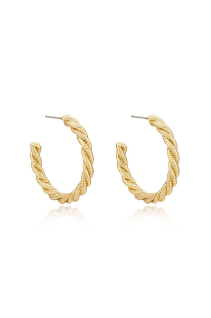 Gold hoop earrings with a twisted design are prominently displayed, reflecting light on a white background, suggesting a chic, elegant accessory suitable for various outfits.