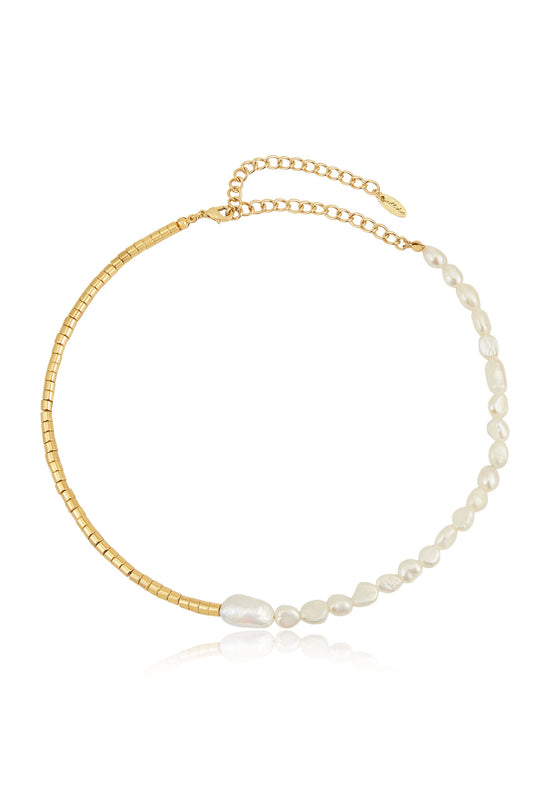 A delicate necklace features alternating sections of small gold beads and irregularly shaped white pearls. It is displayed against a light background, highlighting its elegance and shine.