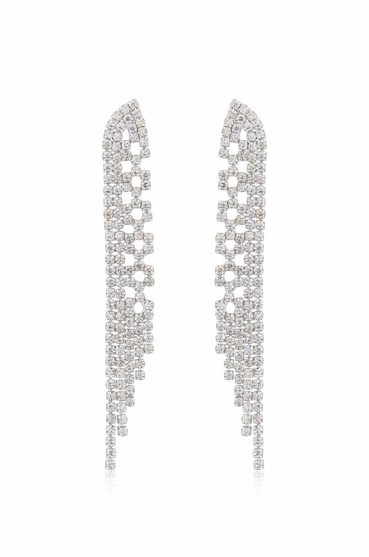 Two elegant earrings adorned with numerous sparkling gems are positioned symmetrically. Their cascading design features clustered squares and rectangles, reflecting light against a clean, white background.