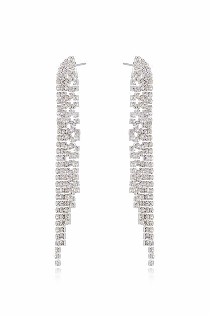 Two long, shimmering earrings made of multiple rows of small, square crystals arranged in a cascading pattern, reflecting light against a neutral background.