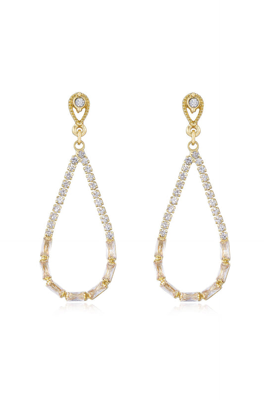 Elegant teardrop earrings adorned with clear and gold accents hang gracefully. They sparkle with a series of small crystals, reflecting light against a simple white background.