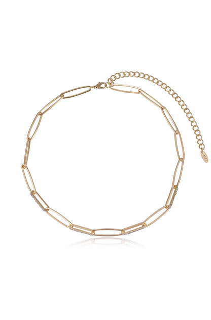 A gold necklace features elongated links interspersed with sparkling elements, designed for elegance. It lies against a plain white background, highlighting its refined style and shine.