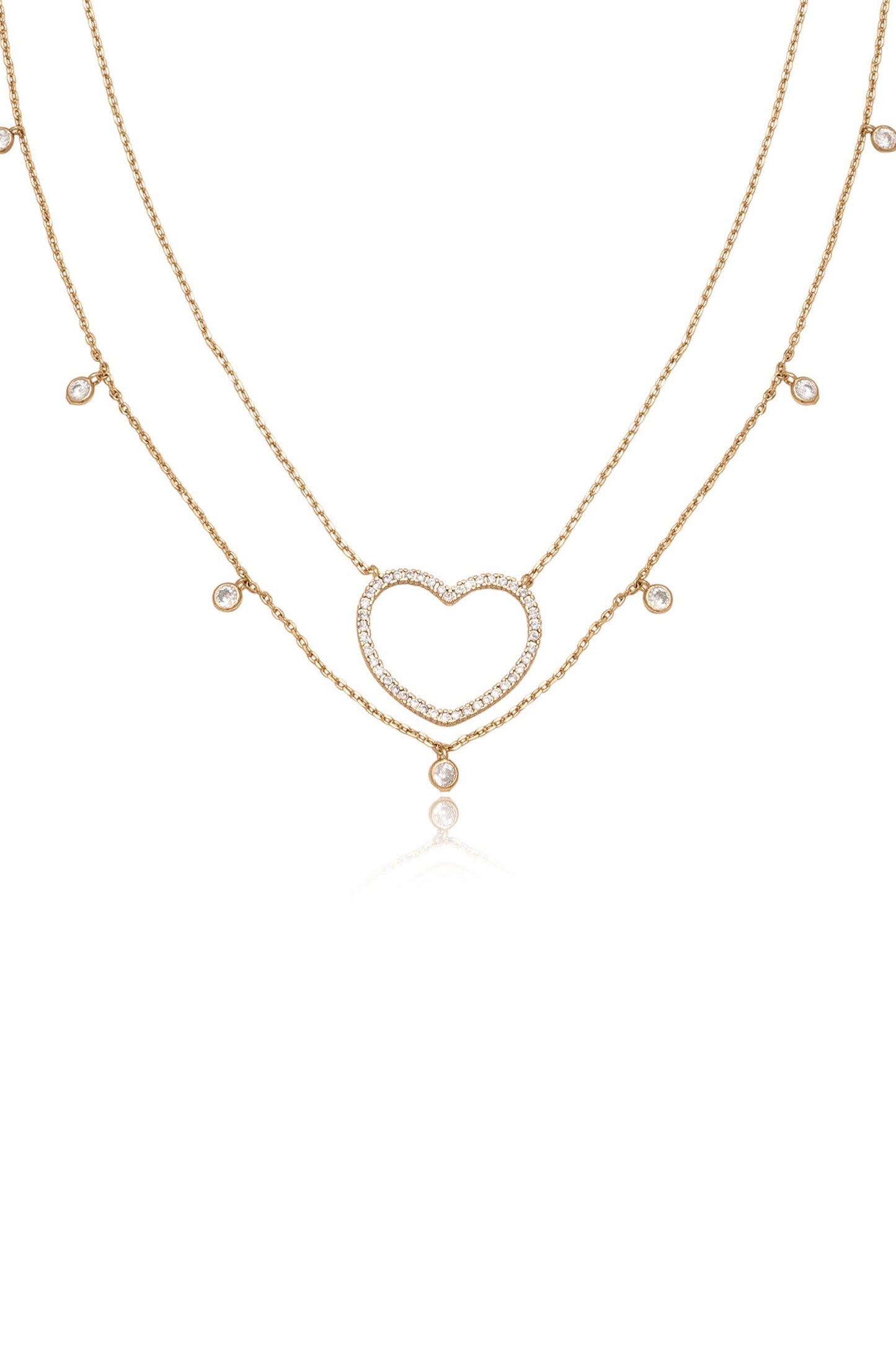 A delicate gold necklace with two layered chains features a heart-shaped pendant adorned with sparkling stones. The design exudes elegance against a plain white background.