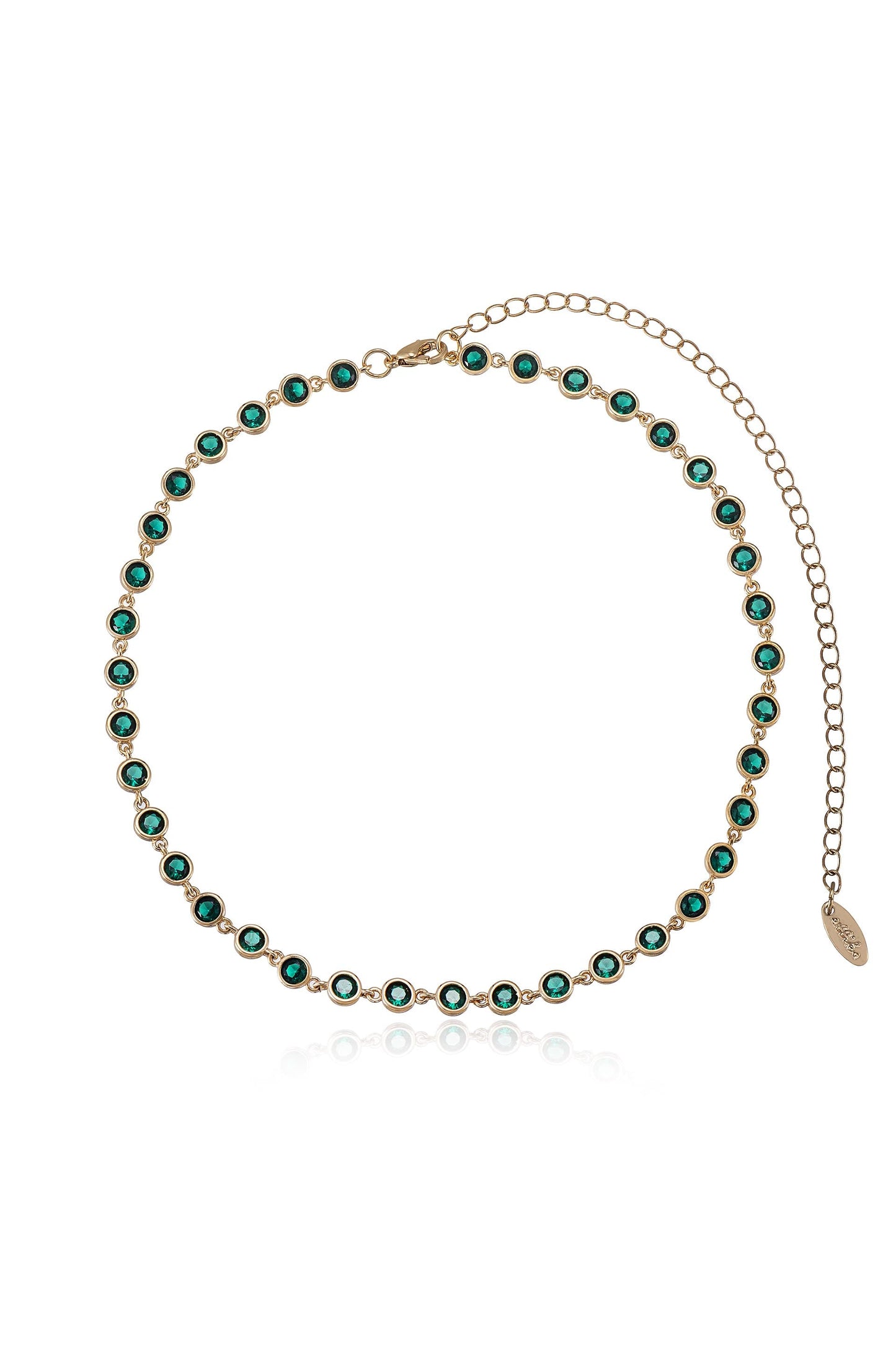 A gold chain necklace adorned with green gemstones is displayed, featuring a clasp and an extender chain for adjustable length, reflecting light against a neutral background.