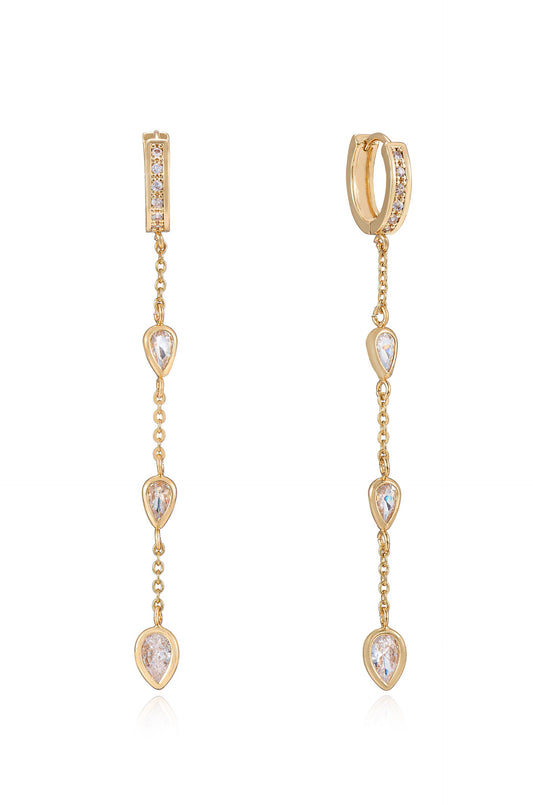 Two elegant gold earrings feature a series of pear-shaped stones hanging from a delicate chain. They are designed to catch light, adding a touch of sophistication.