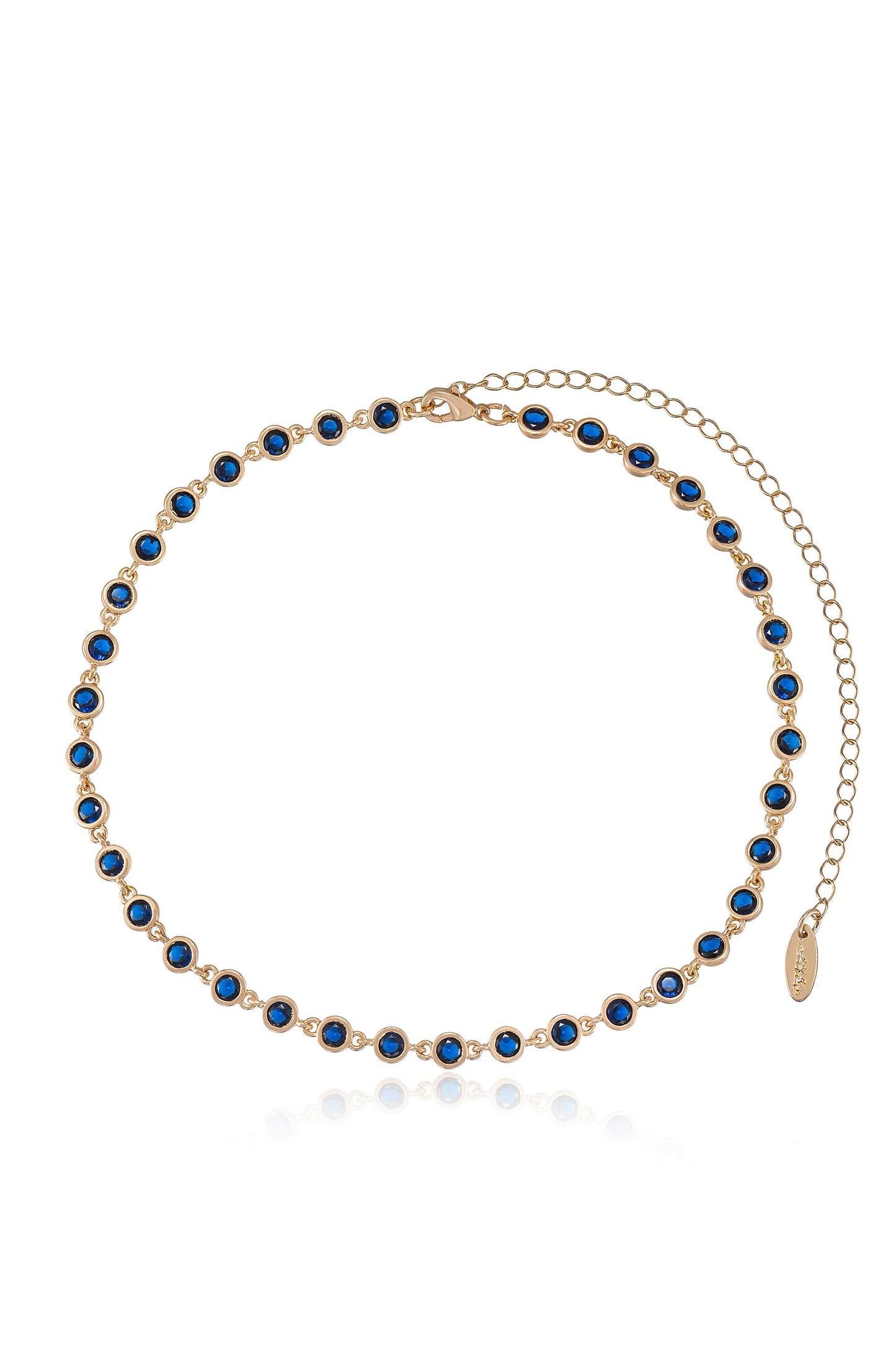 A delicate gold chain necklace features evenly spaced blue gemstones. The necklace is designed for wearing around the neck, showcased against a light background.