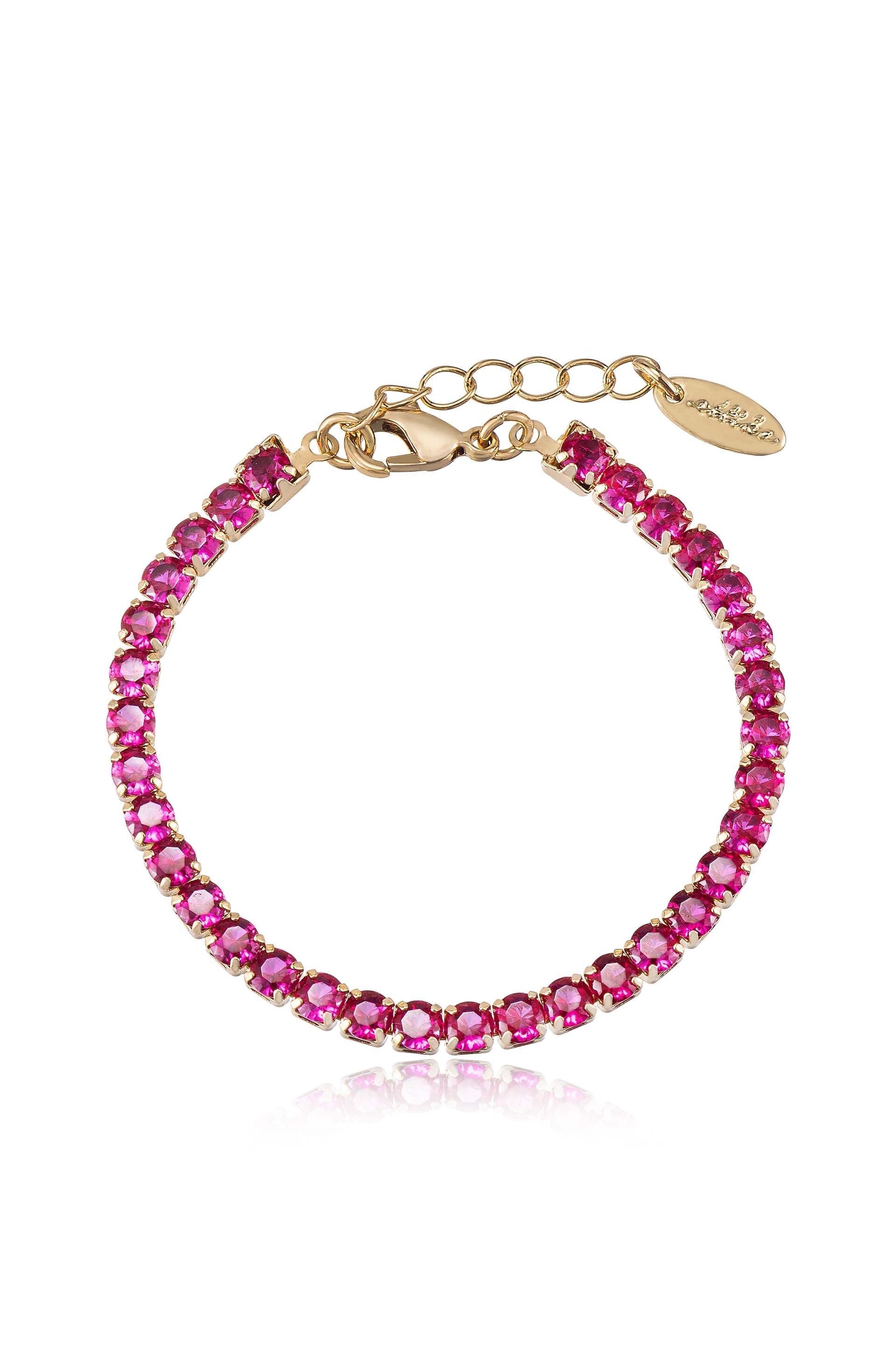 A shiny jewelry bracelet features a line of pink stones set in gold. It clasps with a lobster claw and has an adjustable chain for size flexibility.