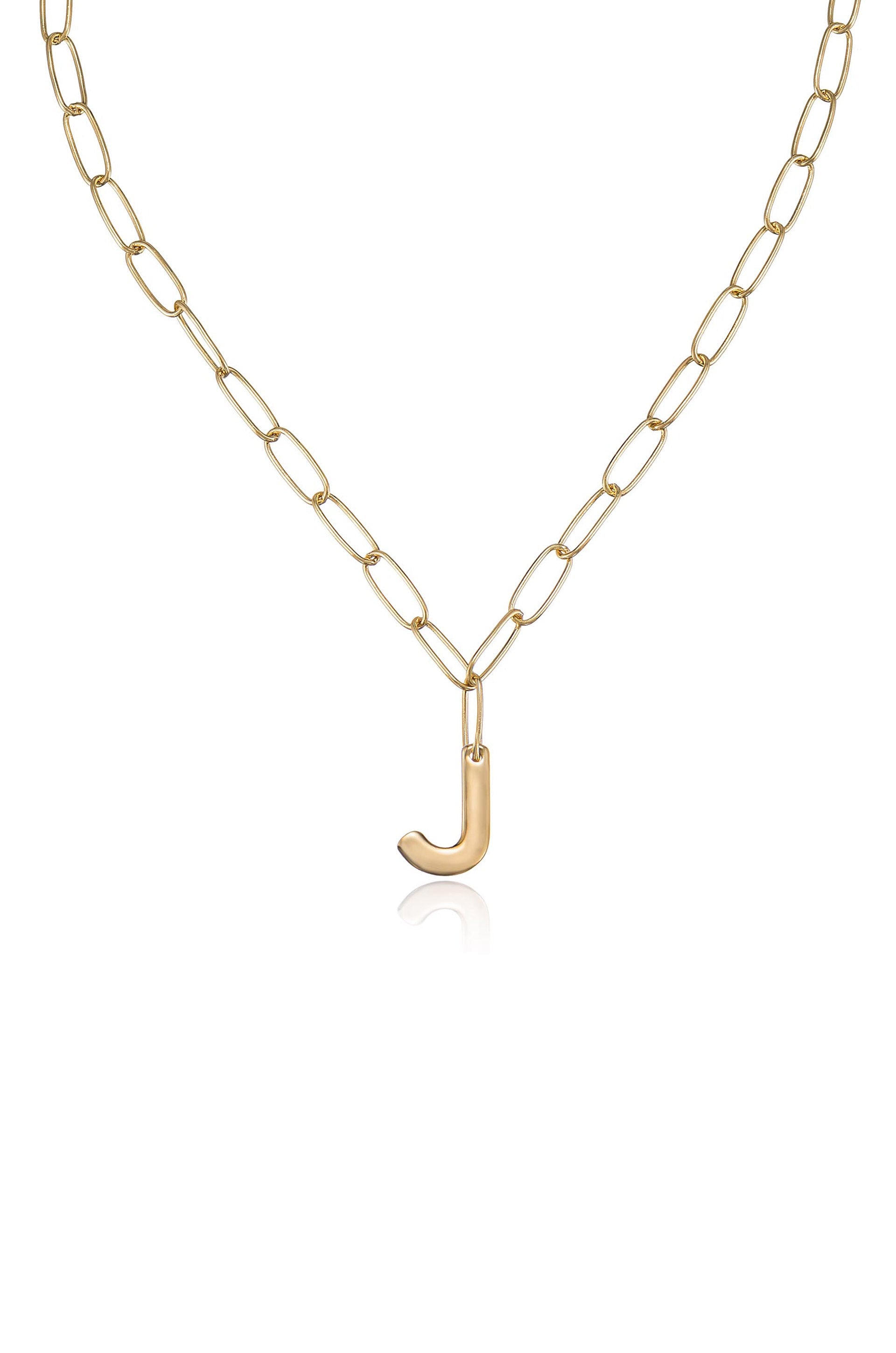 A golden chain necklace features oval links connected together. A lowercase "j" pendant hangs from the center, creating a simple yet elegant piece of jewelry.