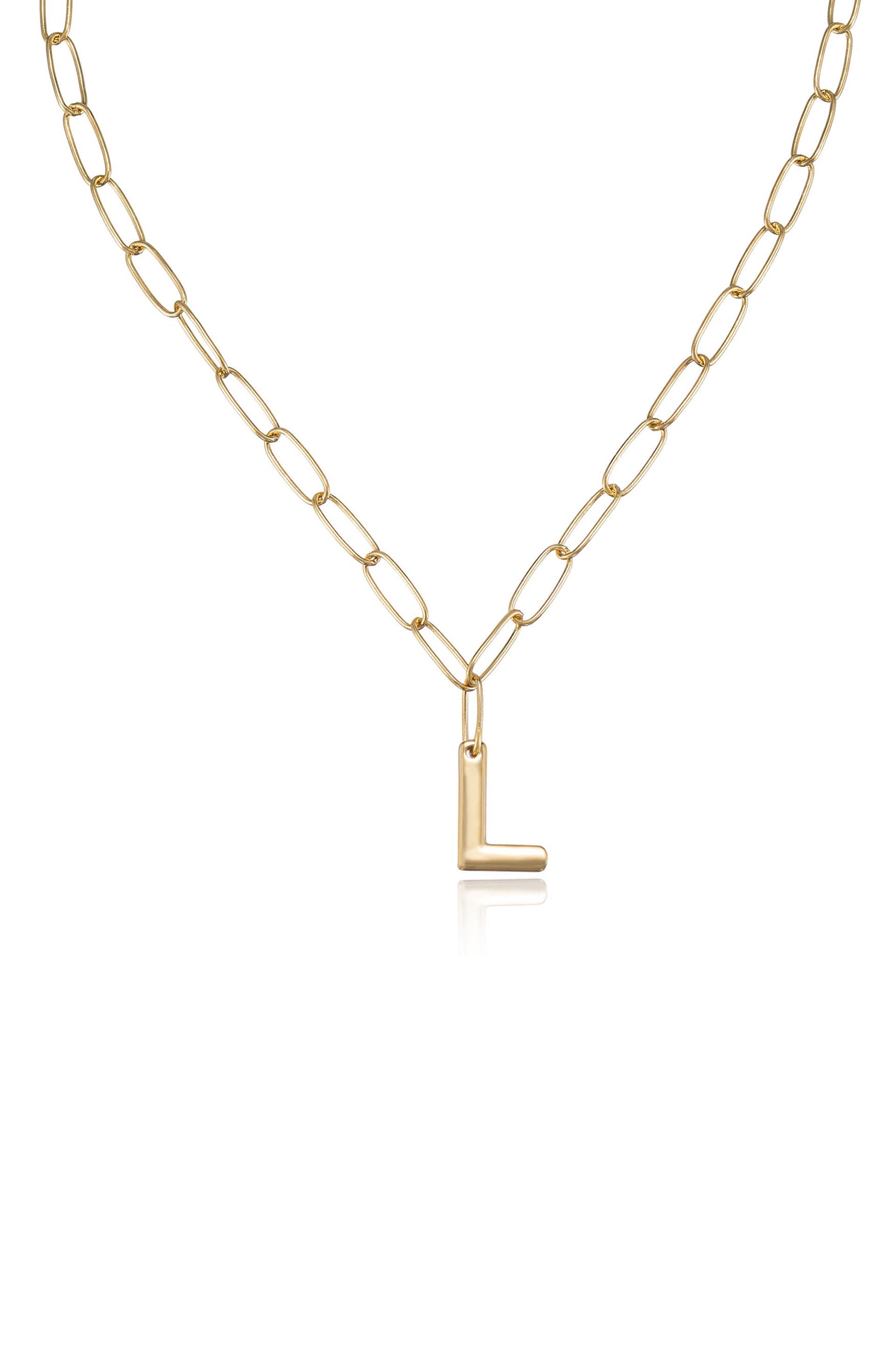 A gold chain necklace features elongated oval links, with a small, shiny gold "L" pendant hanging from it. The background is plain, emphasizing the necklace's design.