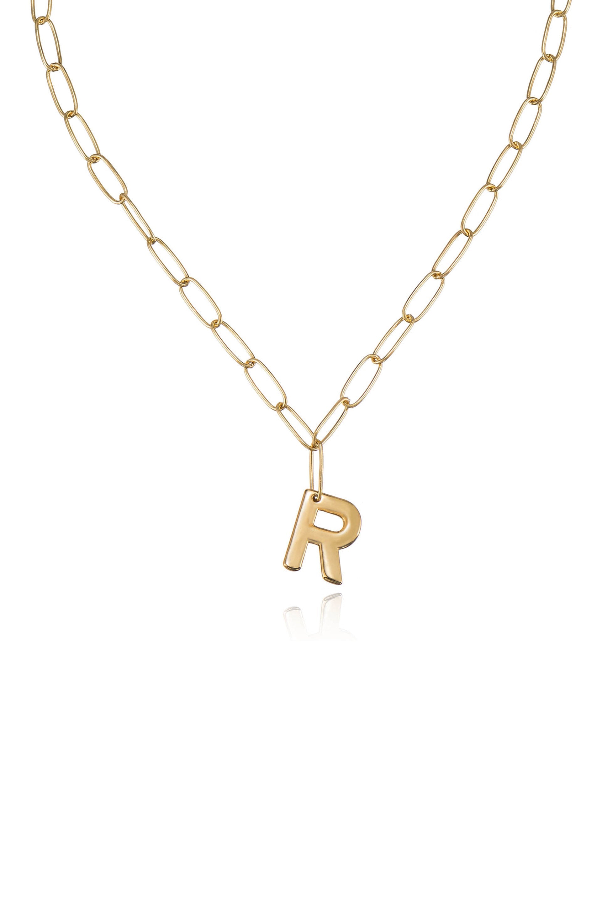 A gold chain necklace features a single gold letter "R" pendant. The necklace is in a plain background, highlighting the shiny metal and simple design.