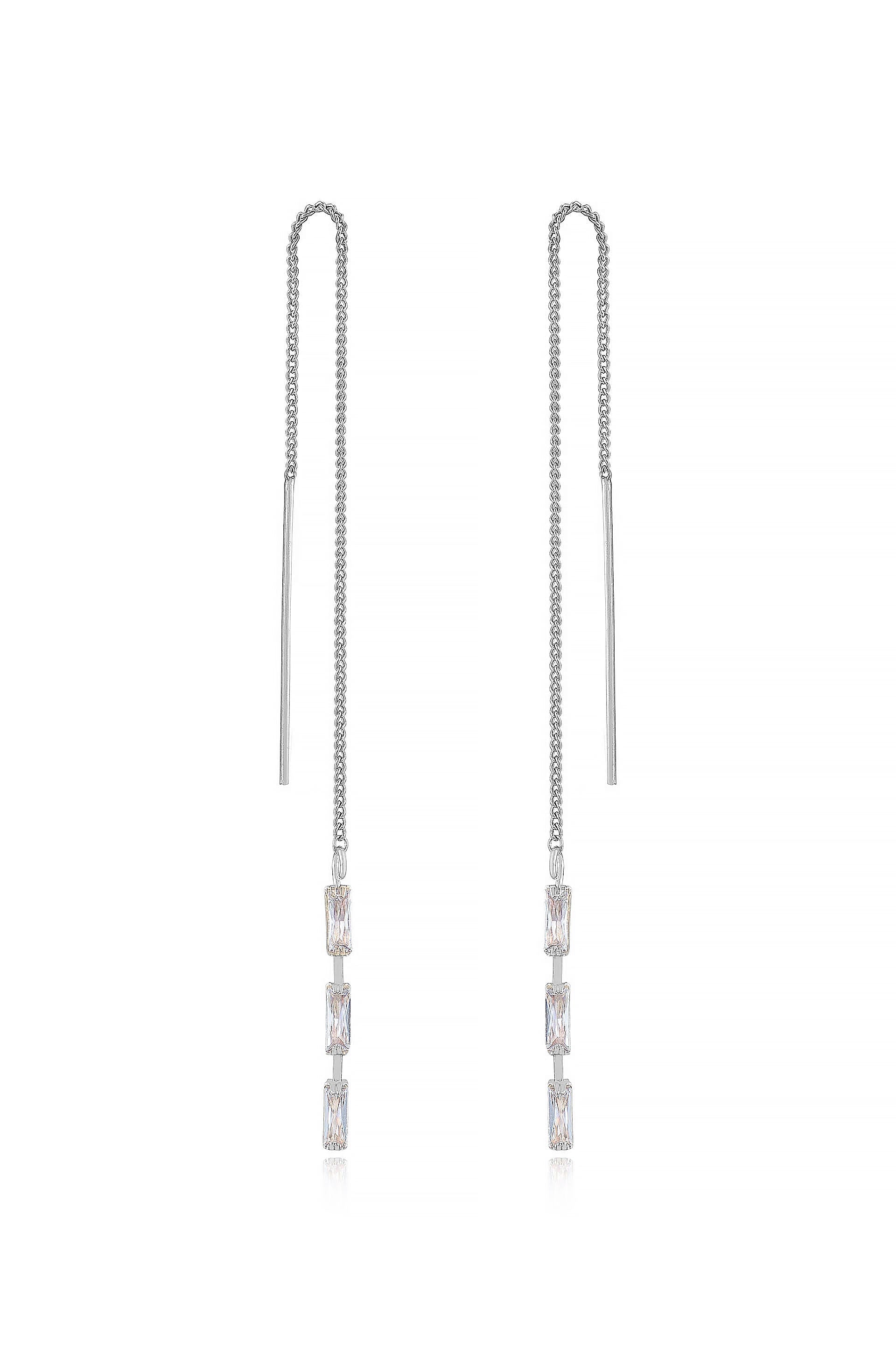 Two elegant silver chain earrings hang vertically, featuring rectangular gemstones that glisten. The background is minimalistic, enhancing the jewelry's shine and design.