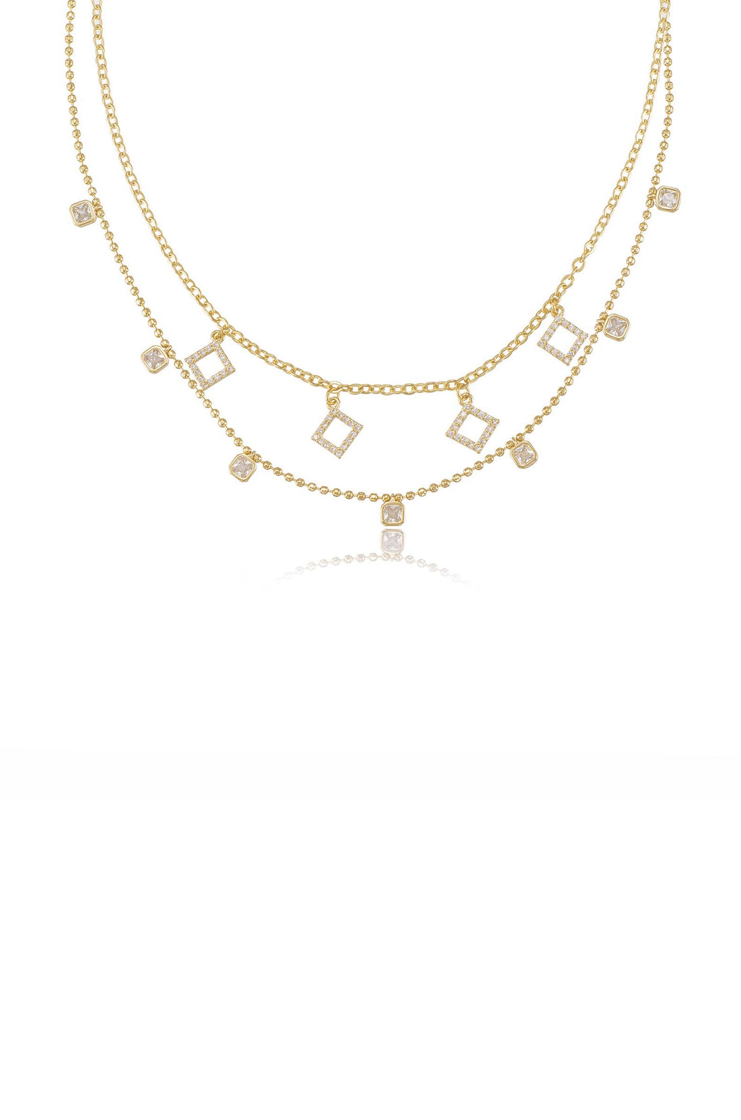 A gold necklace features multiple chains adorned with rectangular and square-shaped crystal accents, elegantly draping with a shiny finish on a plain white background.