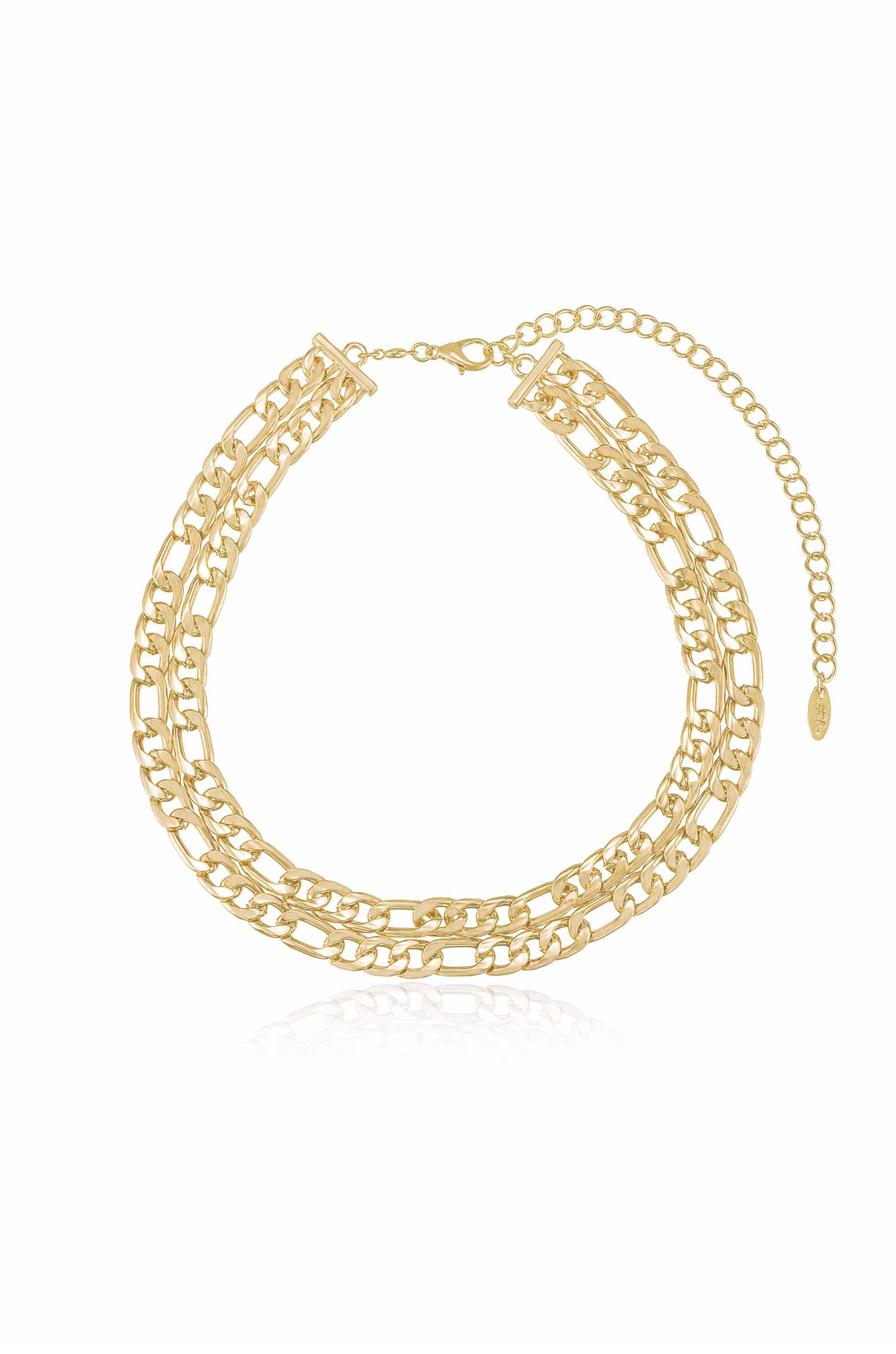 A gold chain necklace with multiple layers features linked sections, creating a bold appearance. It is displayed against a plain white background, emphasizing its shine and details.