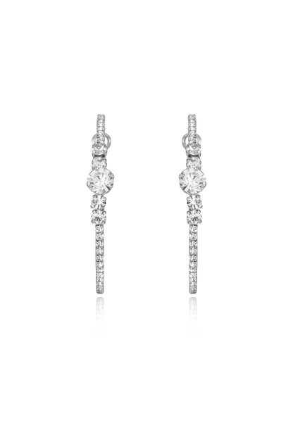 Two elegant earrings featuring sparkling gems, positioned symmetrically. They appear to dangle freely, reflecting light, on a plain white background, emphasizing their shine and design.