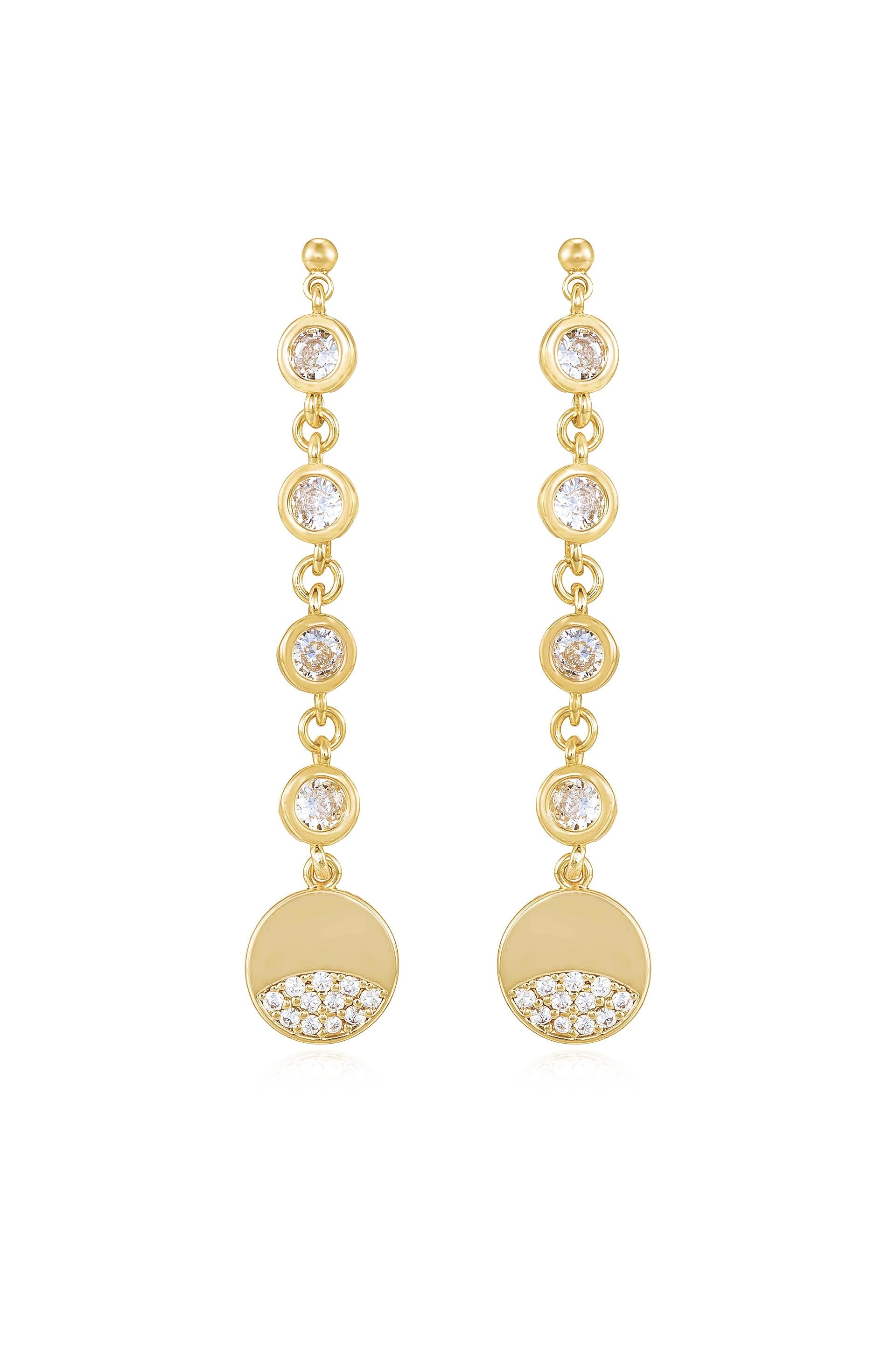 Gold earrings feature dangling elements with circular designs. Each earring has several sparkling gems arranged along the chain, culminating in a round disc adorned with smaller stones at the bottom.