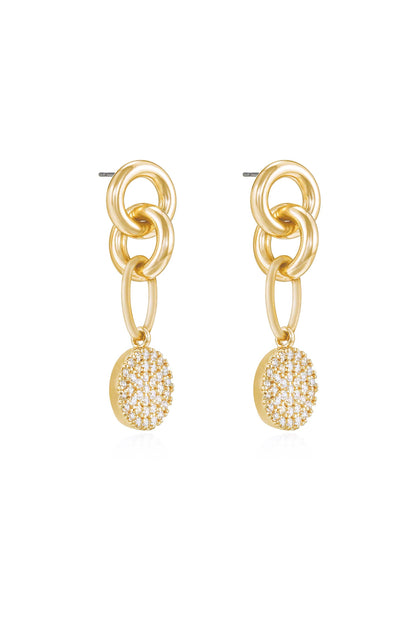 Gold earrings feature interlinked circular chains, dangling from which is a round pendant embellished with sparkling crystals, creating a stylish and elegant accessory suitable for various occasions.