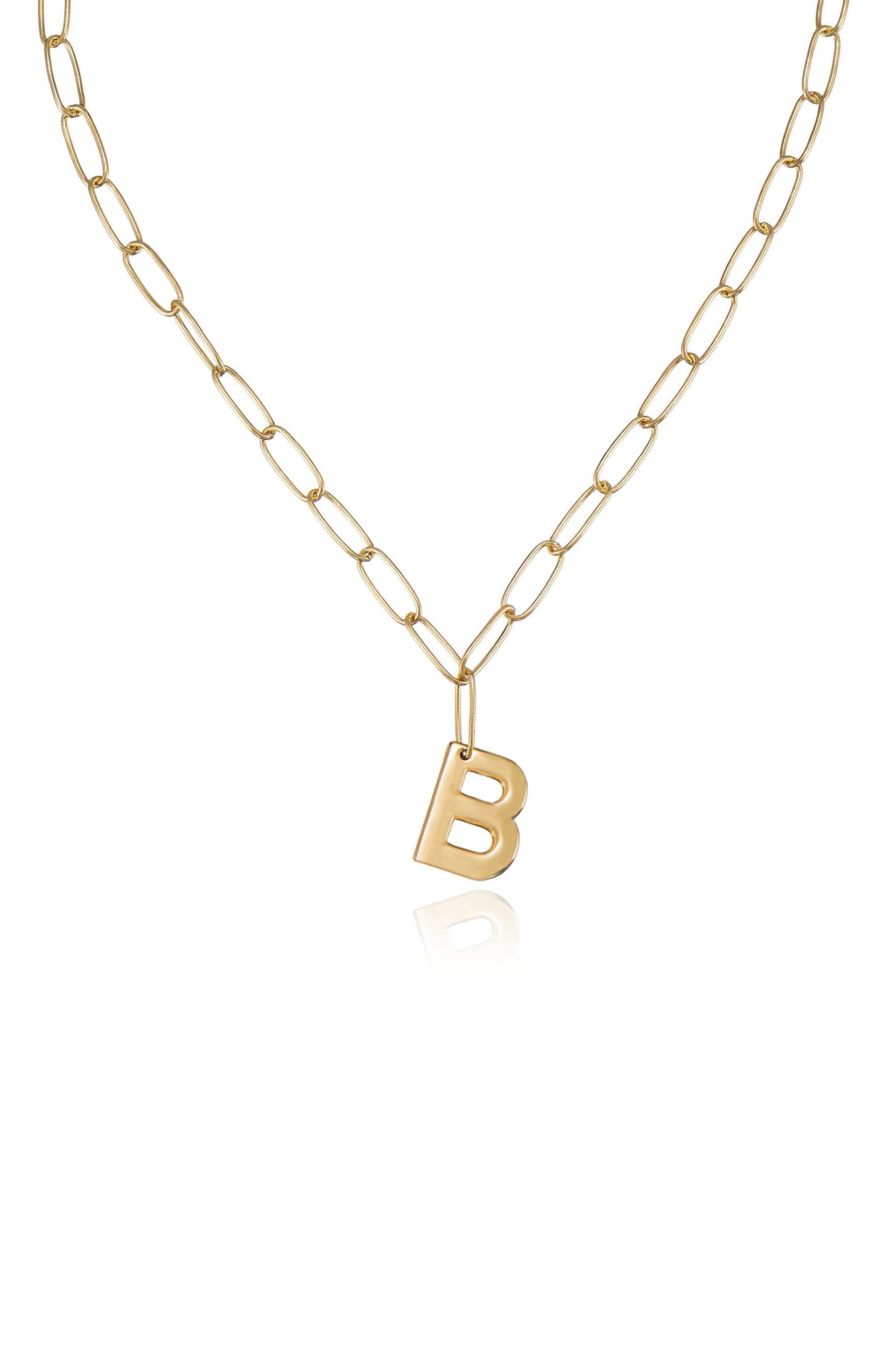 A gold chain necklace features elongated links, with a prominent "B" pendant hanging at its center. The necklace is displayed against a light background, emphasizing its shine and design.