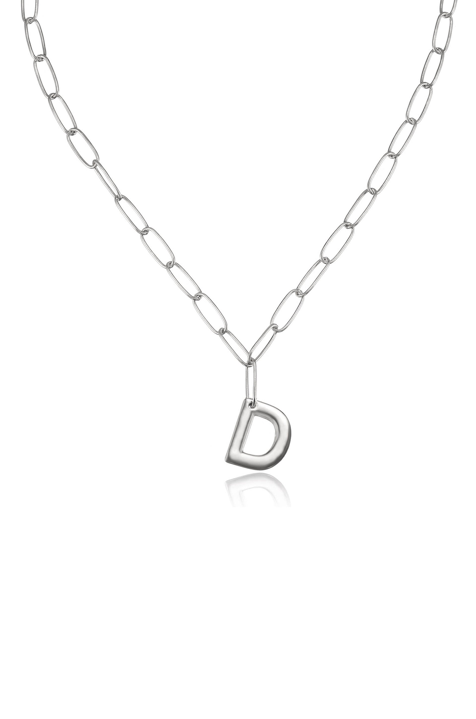 A silver chain necklace features an oversized, shiny letter "D" pendant, suspended at the center. The background is plain white, highlighting the necklace's design.