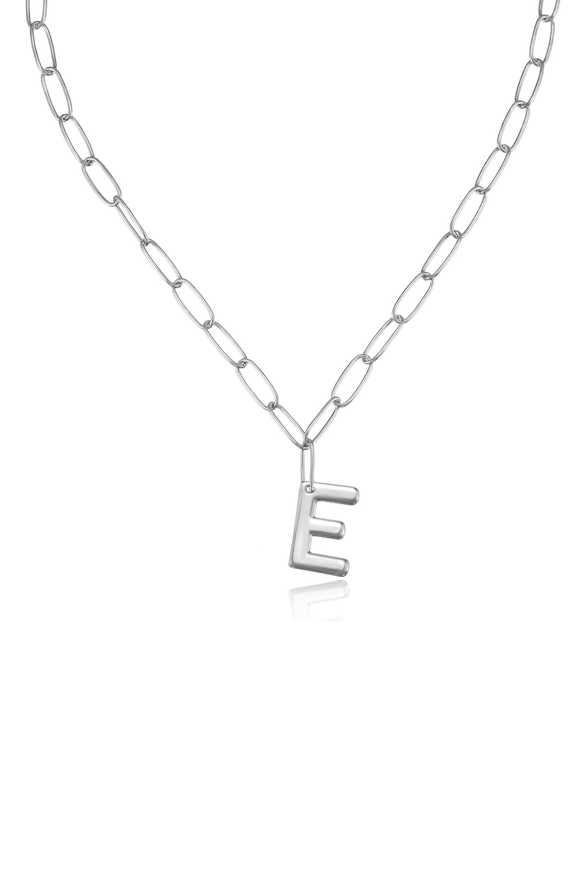 A silver chain necklace features an embossed letter "E" pendant dangling from it, set against a plain white background, highlighting its metallic shine and simple design.