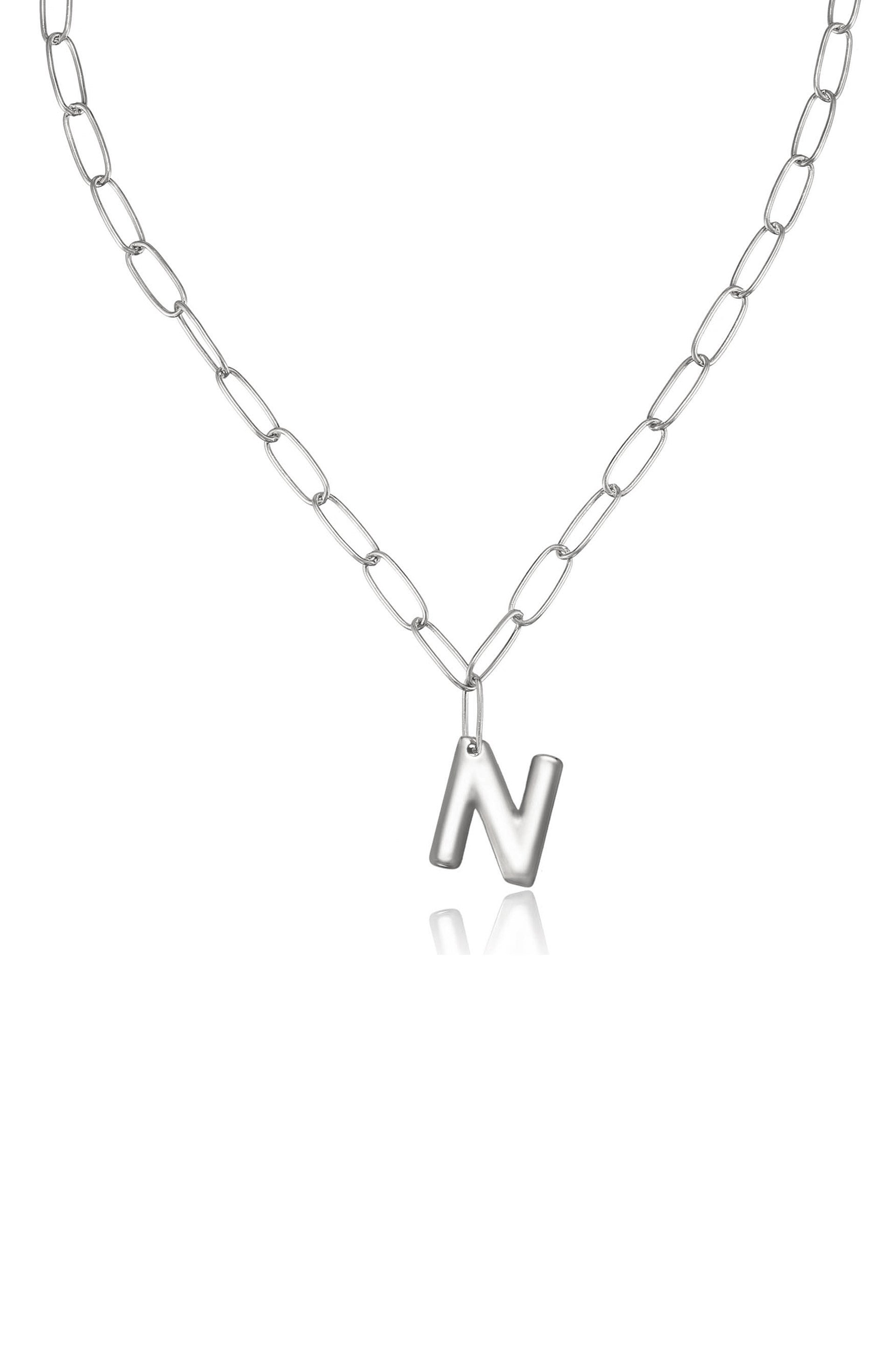 A silver chain necklace features a prominent letter "N" pendant hanging in the center, displayed against a plain, light background, emphasizing its sleek design and polished finish.