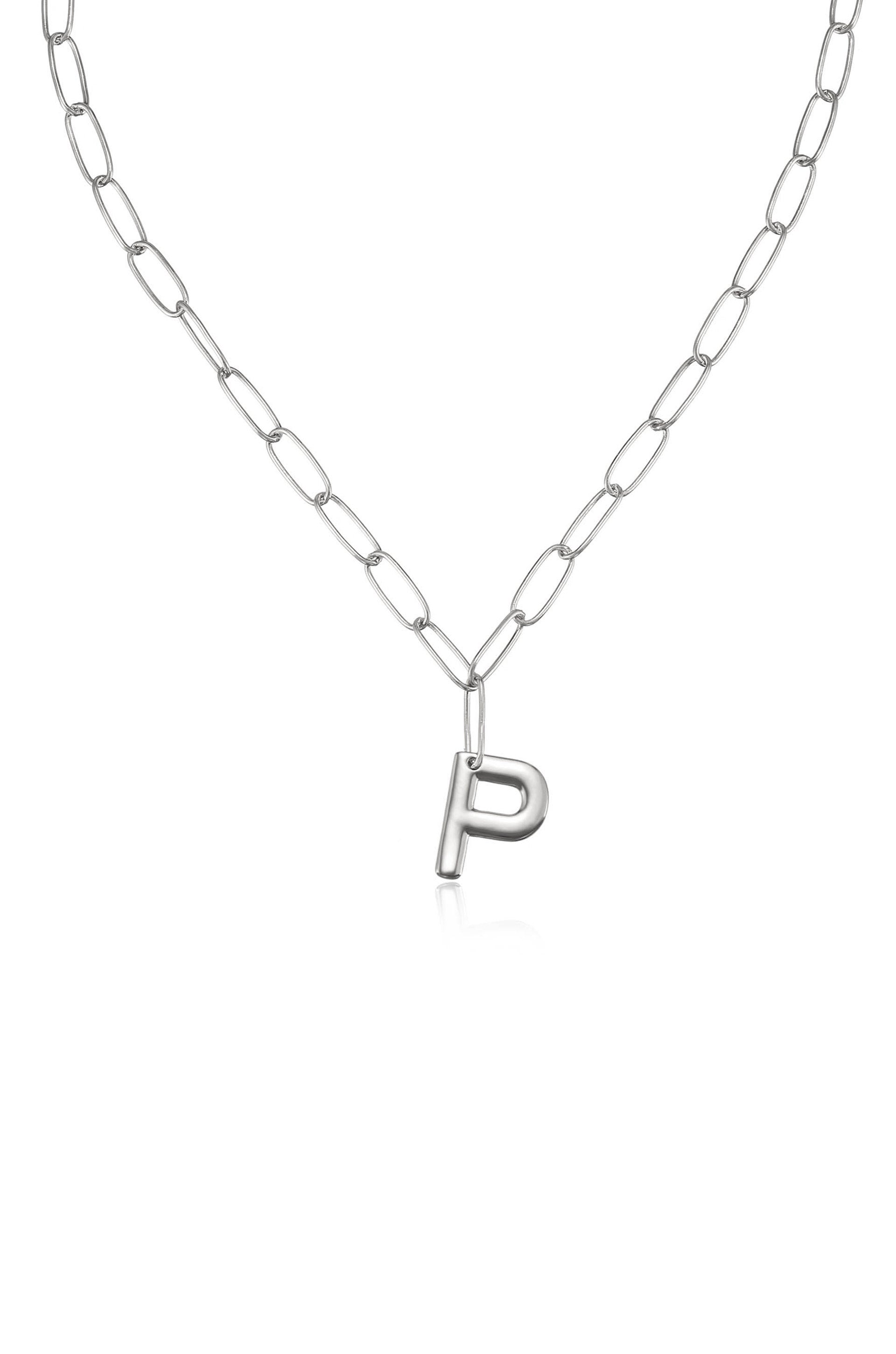 A silver chain necklace features elongated links with a prominent, shiny letter "P" pendant hanging from it, set against a plain, light background.