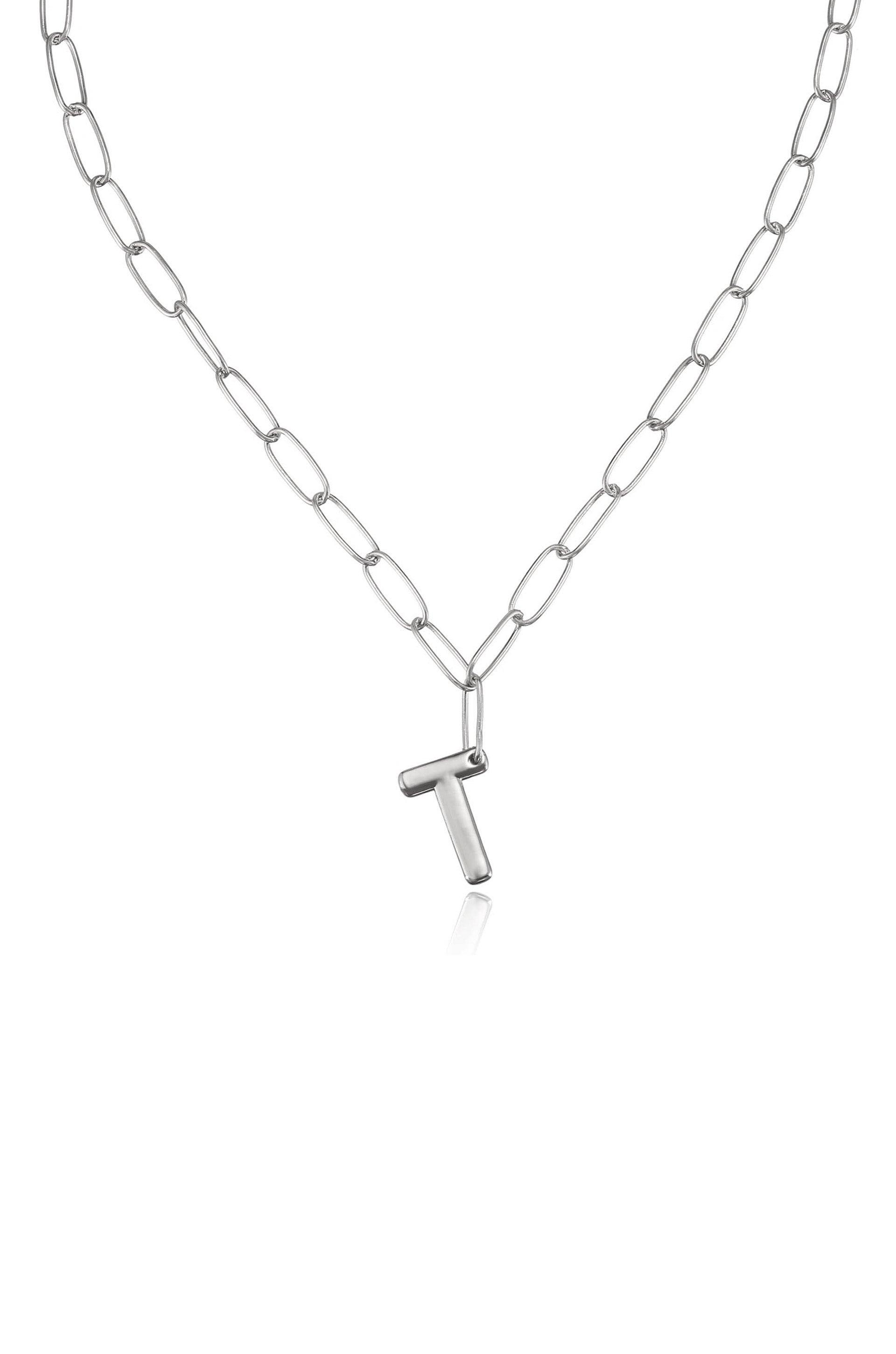 A silver chain necklace features elongated links and a prominent 'T' shaped pendant, showcasing a simple and modern design against a plain white background.