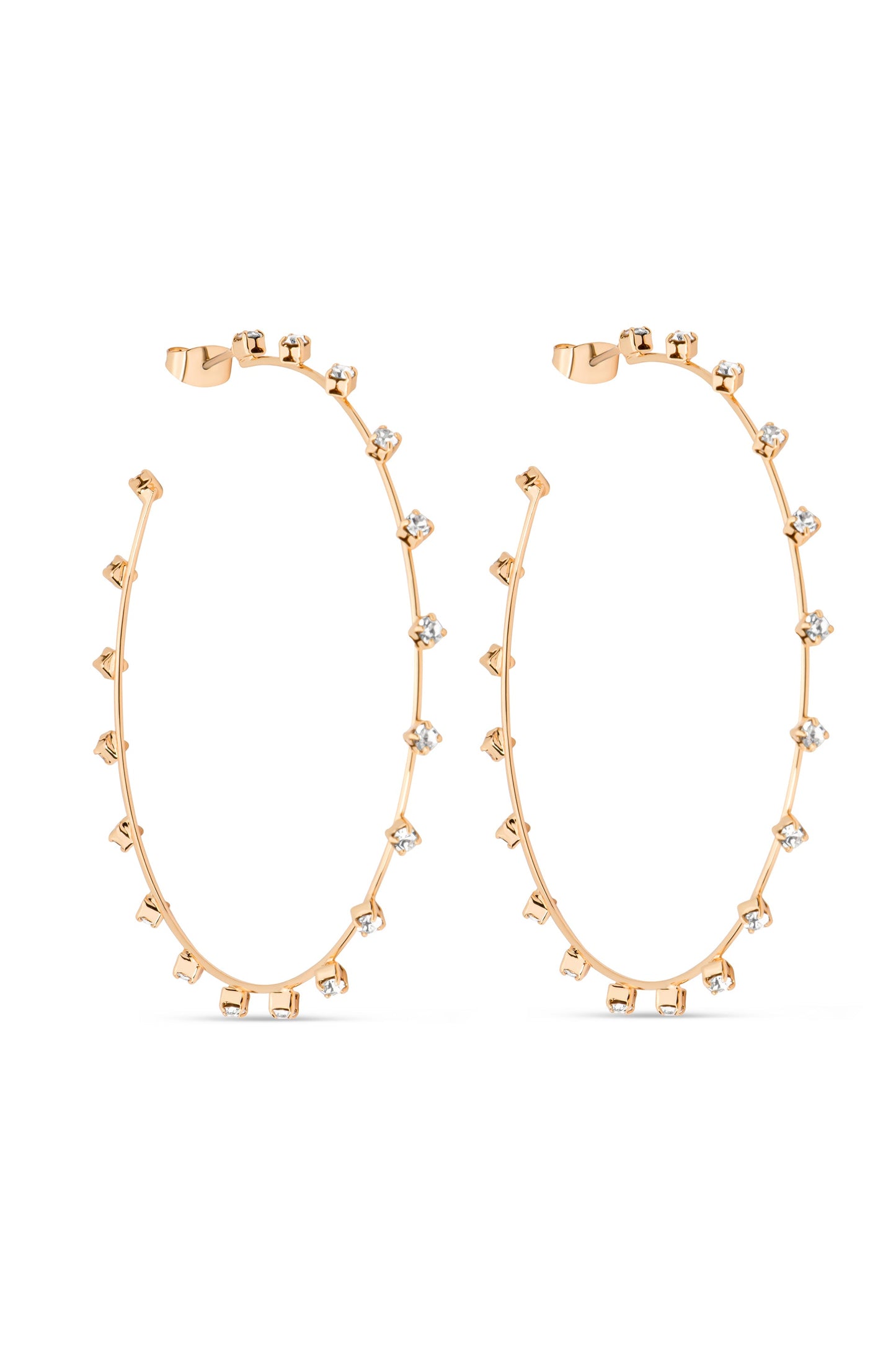 Gold hoop earrings embellished with small, sparkling stones are displayed against a white background, highlighting their elegant design. The earrings are slightly curved, adding a modern touch to a classic style.