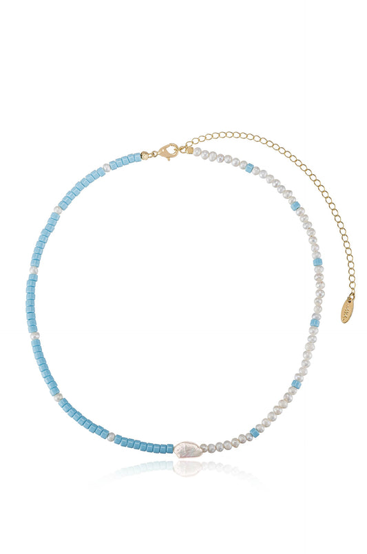 A beaded necklace features alternating light blue square beads and small white pearls, with a central pearlescent bead, connected by a delicate gold chain and clasp on one end.