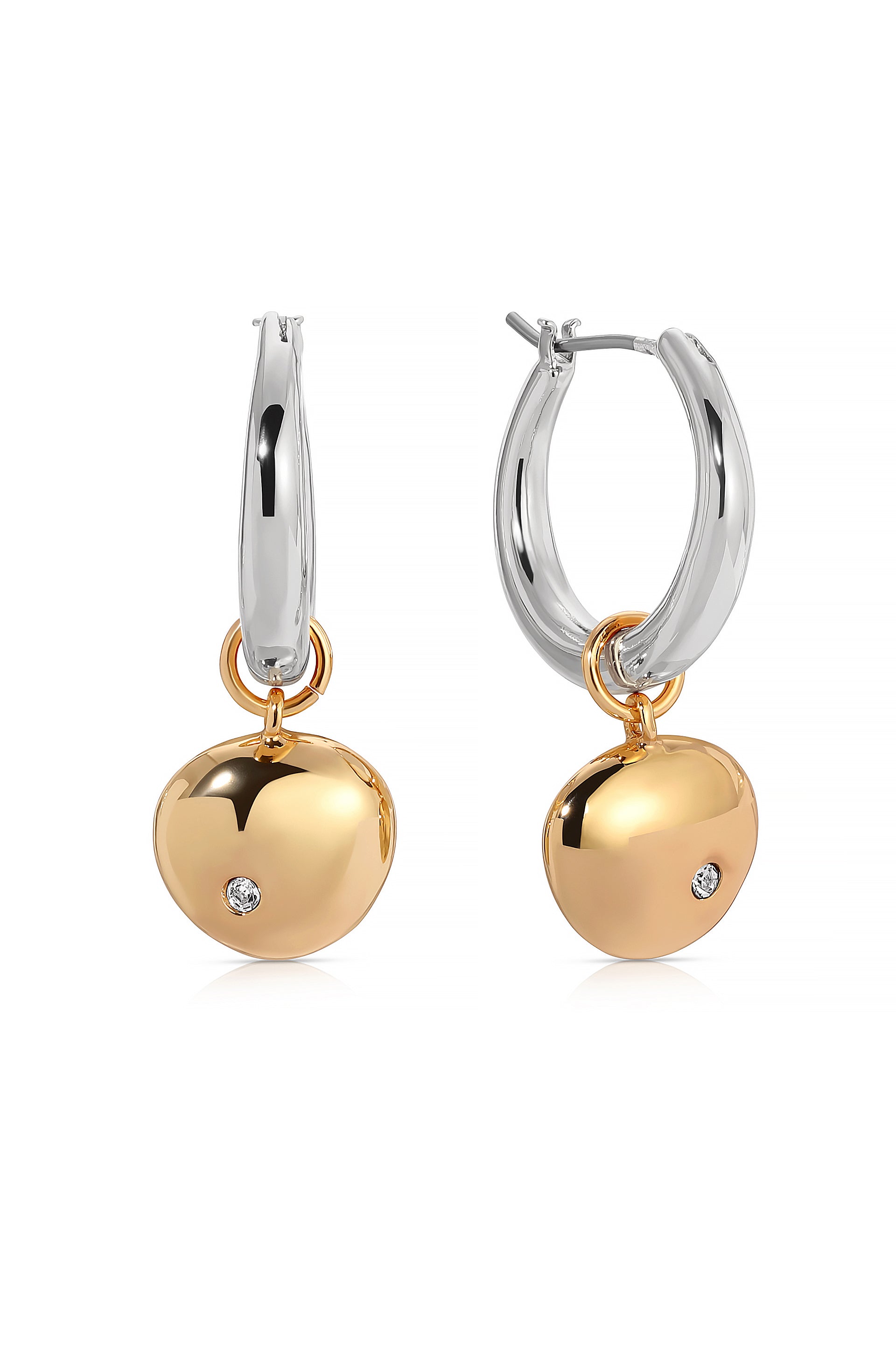 Gold and silver hoop earrings are displayed, featuring shiny, rounded pendants with a small diamond detail. They hang elegantly, emphasizing a modern jewelry design aesthetic against a white background.