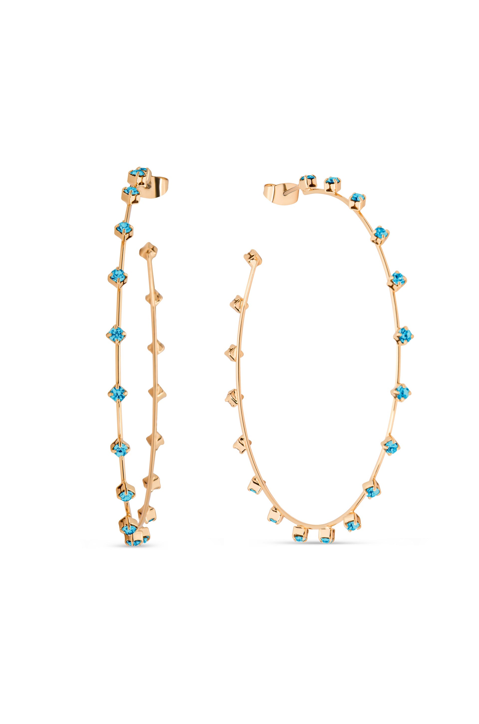 Two gold hoop earrings stand side by side, embellished with blue gemstones. Their slender design features alternating shapes and colors, showcasing elegance against a plain white background.