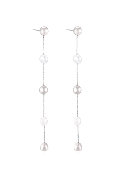 A pair of elegant, long earrings features alternating beads, some shiny and silver-grey and others smooth and white. They hang straight down, suitable for a formal or stylish occasion.