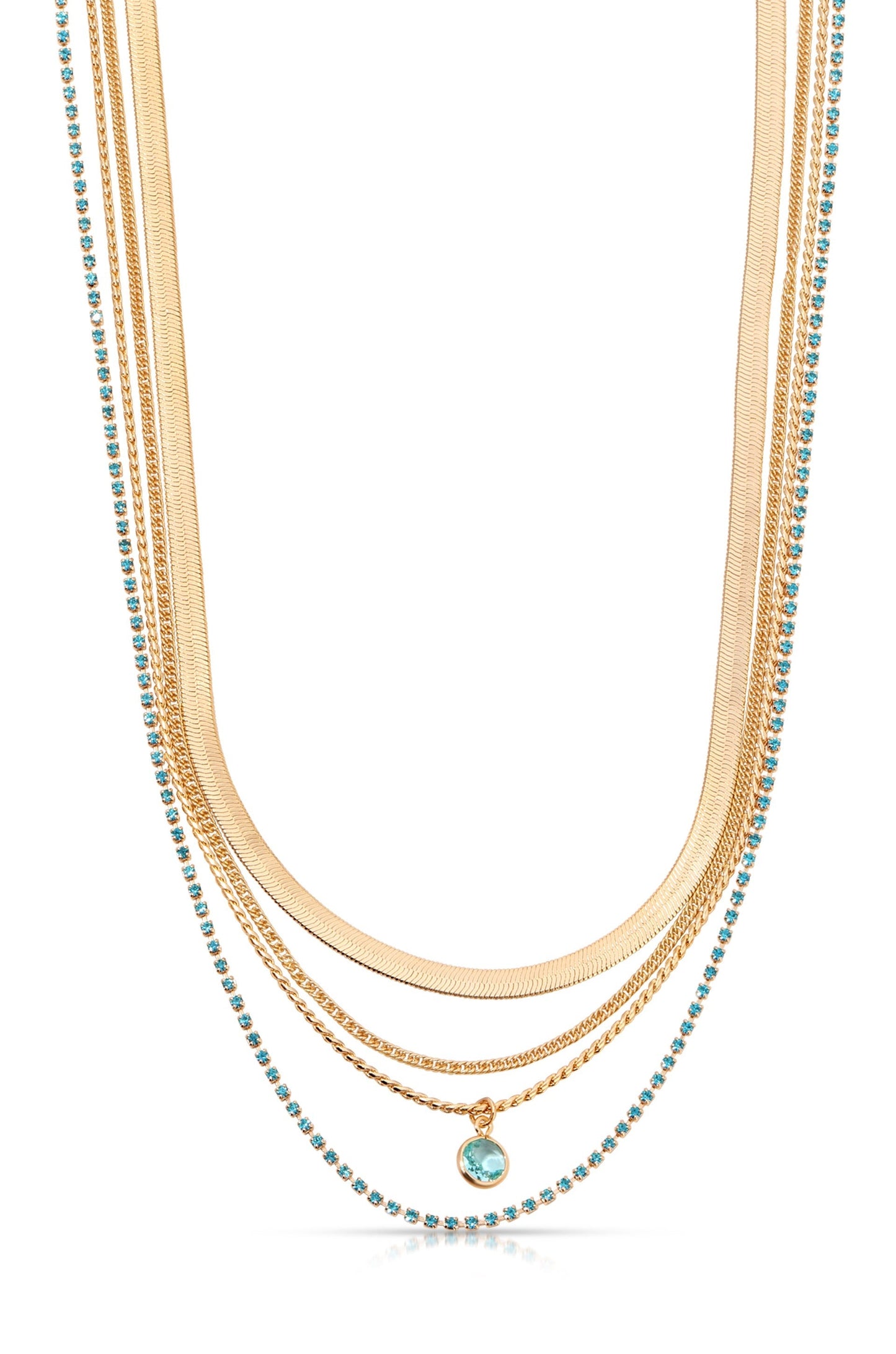 A layered gold necklace features multiple chains of varying thicknesses, adorned with small turquoise stones. The necklace is elegantly displayed against a white background, highlighting its intricate design.