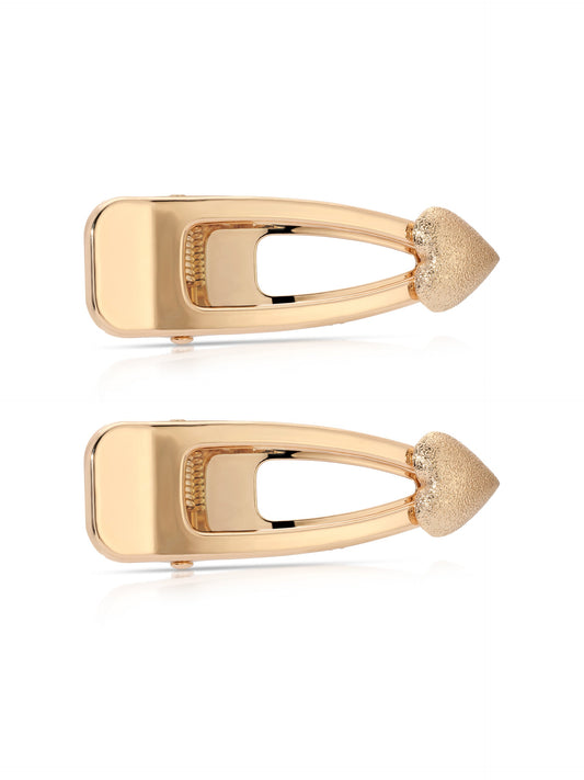 Two gold-colored hair clips are positioned side by side. They feature a sleek, elongated design with a textured, pointed end. The background is plain white, emphasizing the clipsâ€™ reflective surface.