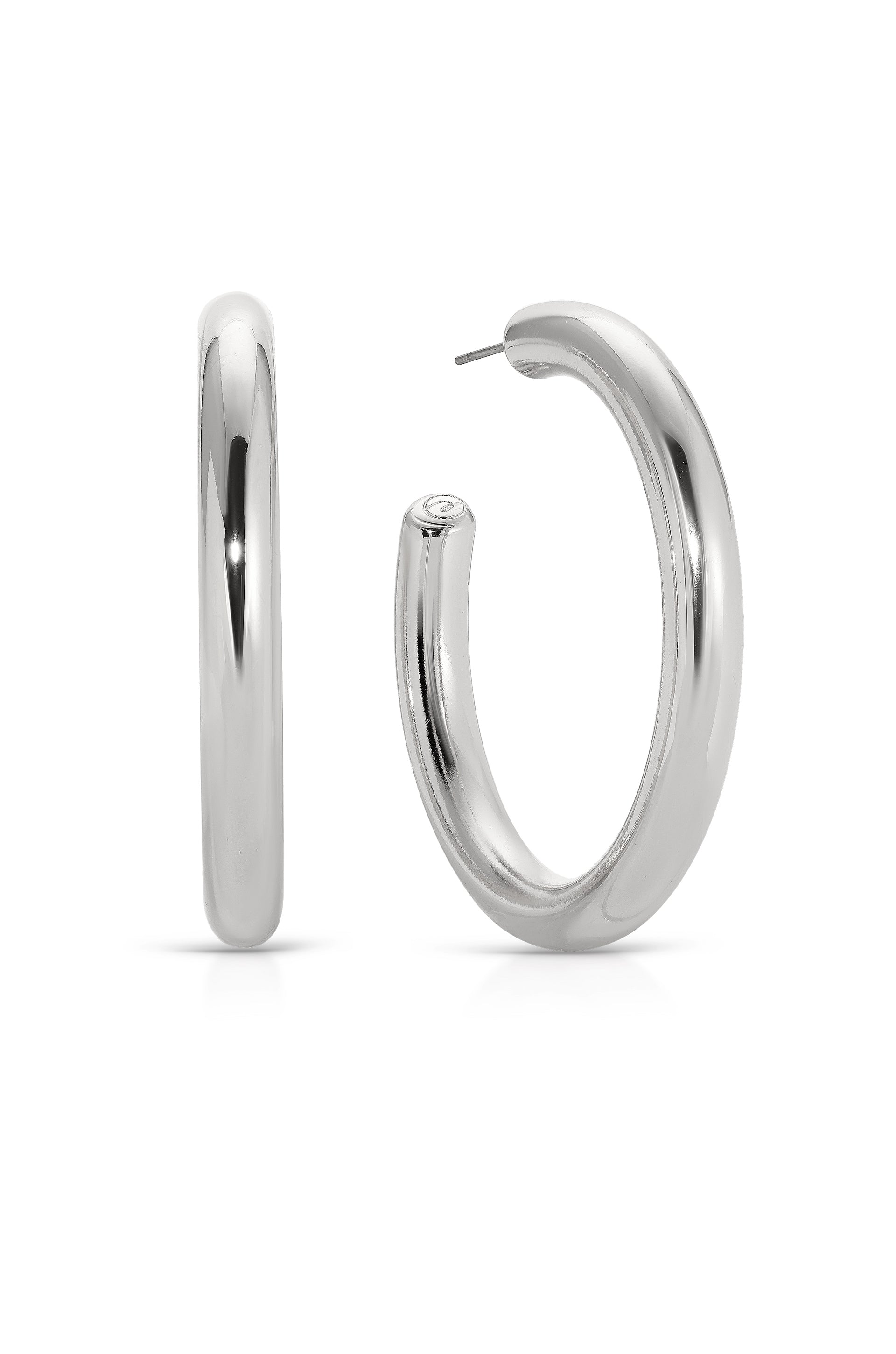 Two silver hoop earrings are displayed, one upright and one slightly turned. The shiny surface reflects light, showcasing their smooth, rounded design, suitable for casual or formal wear.