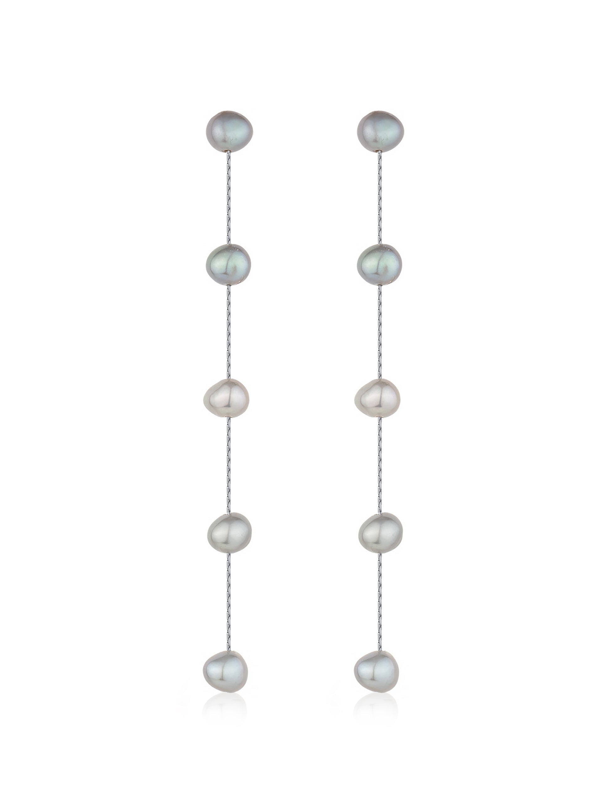 Dangling earrings composed of alternating, glossy, irregularly shaped pearls in muted shades of gray and white are suspended from a delicate silver chain against a plain white background.