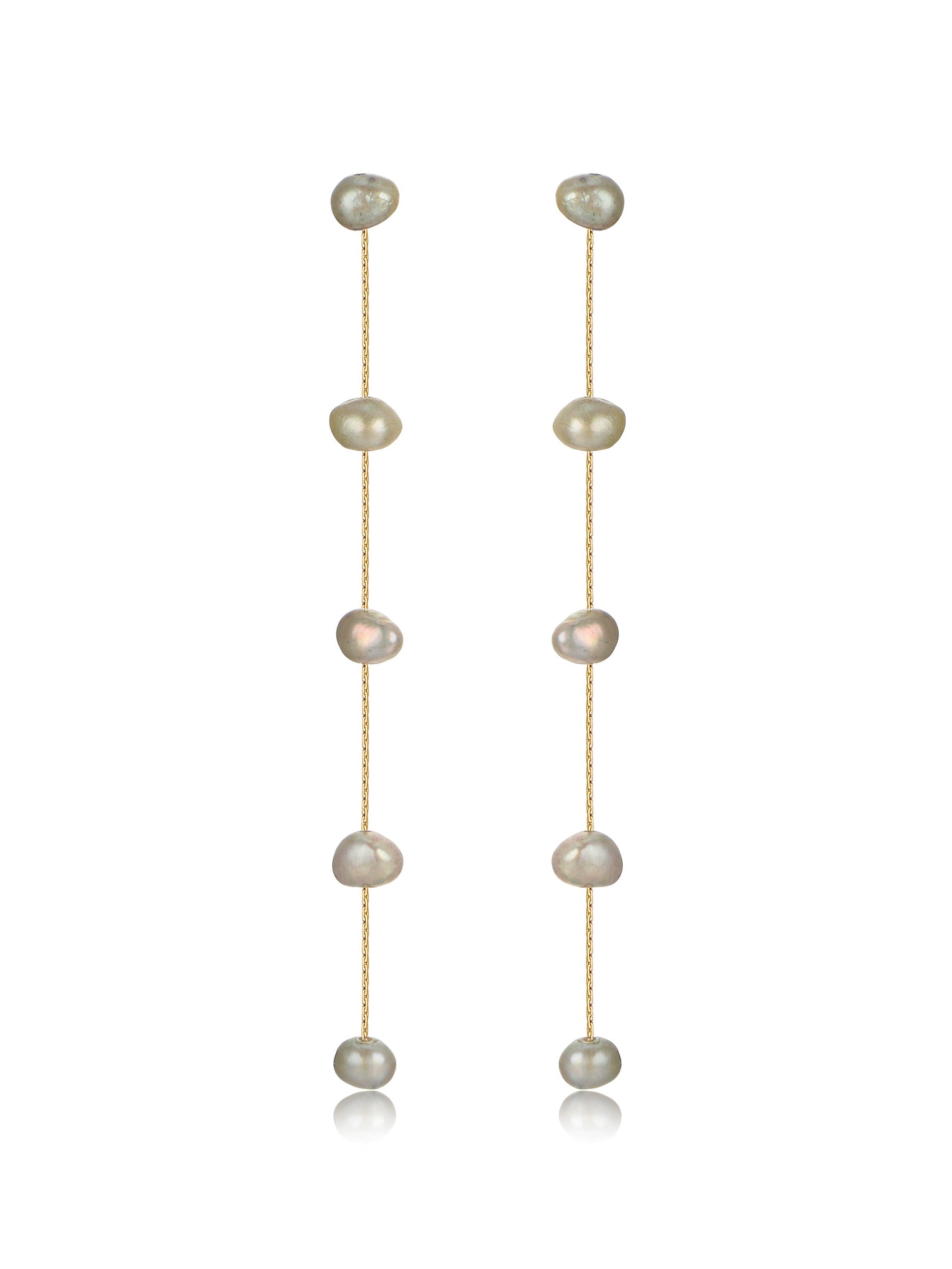 Two delicate earrings hang vertically, featuring a series of irregularly shaped pearls strung on thin gold chains, with a smooth, reflective surface enhancing their elegance against a plain background.