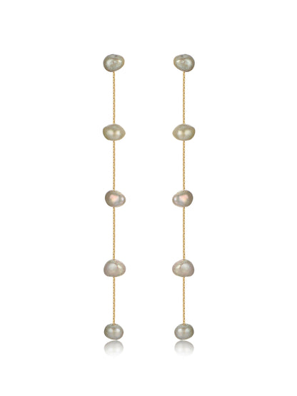 Two delicate earrings hang vertically, featuring a series of irregularly shaped pearls strung on thin gold chains, with a smooth, reflective surface enhancing their elegance against a plain background.