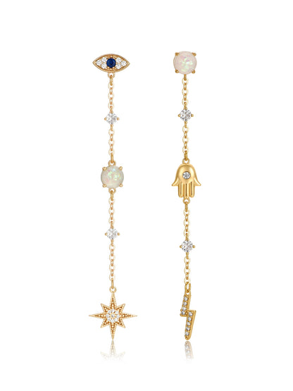 Two decorative earrings hang, featuring an eye and hand motif at the top, gold chains with gemstones and diamond-like elements, and a star and lightning bolt as pendant charms.