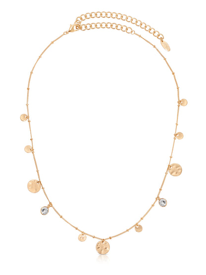 A delicate gold necklace features a series of small discs and sparkling stones, elegantly arranged along a fine chain, suitable for casual or formal outfits.